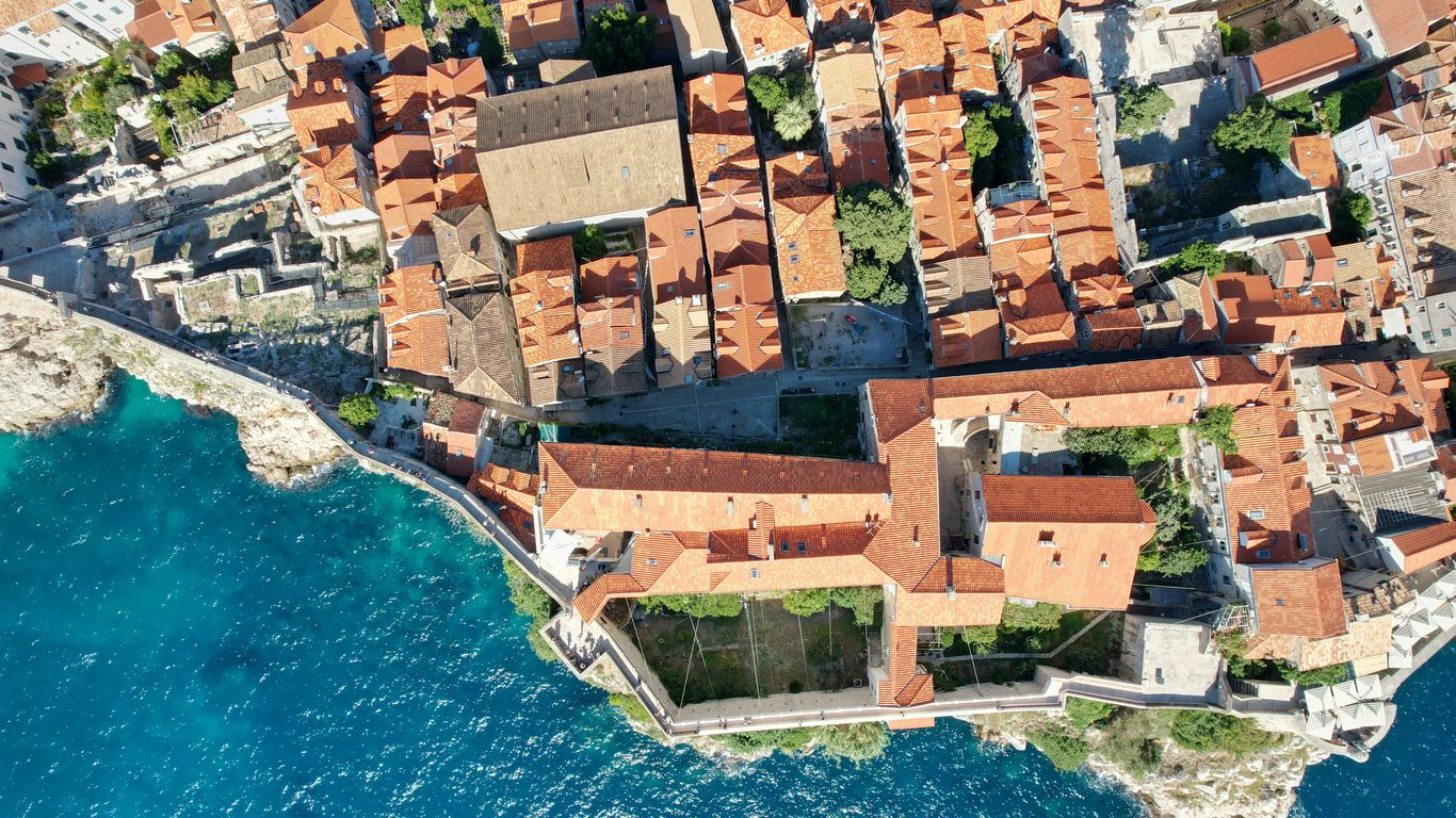 an aerial view of a small village by the water