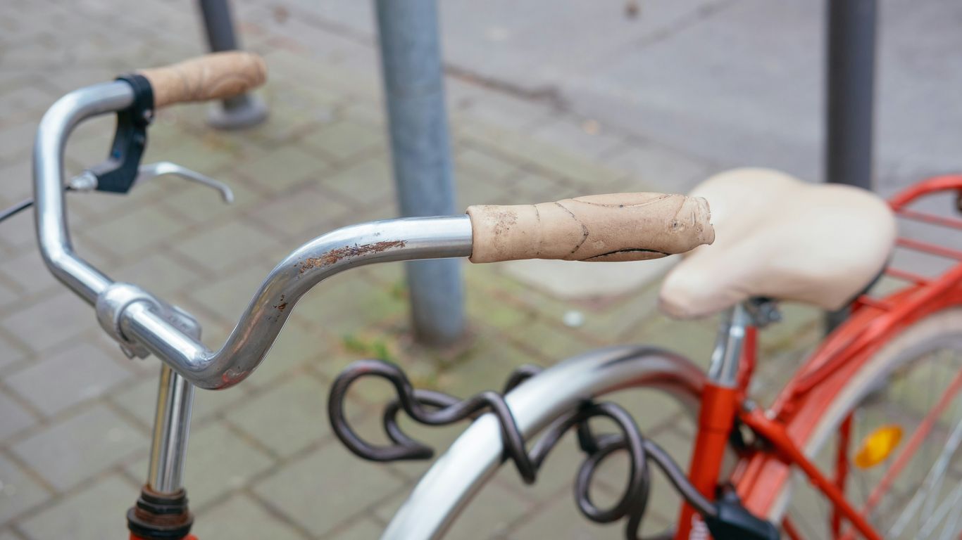 A bicycle's handlebars and seat, close-up.