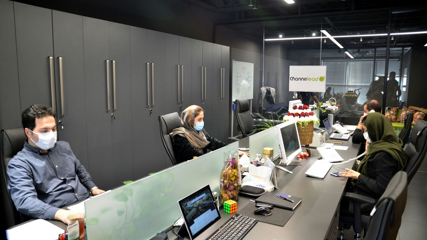 man in black jacket sitting on black office rolling chair
