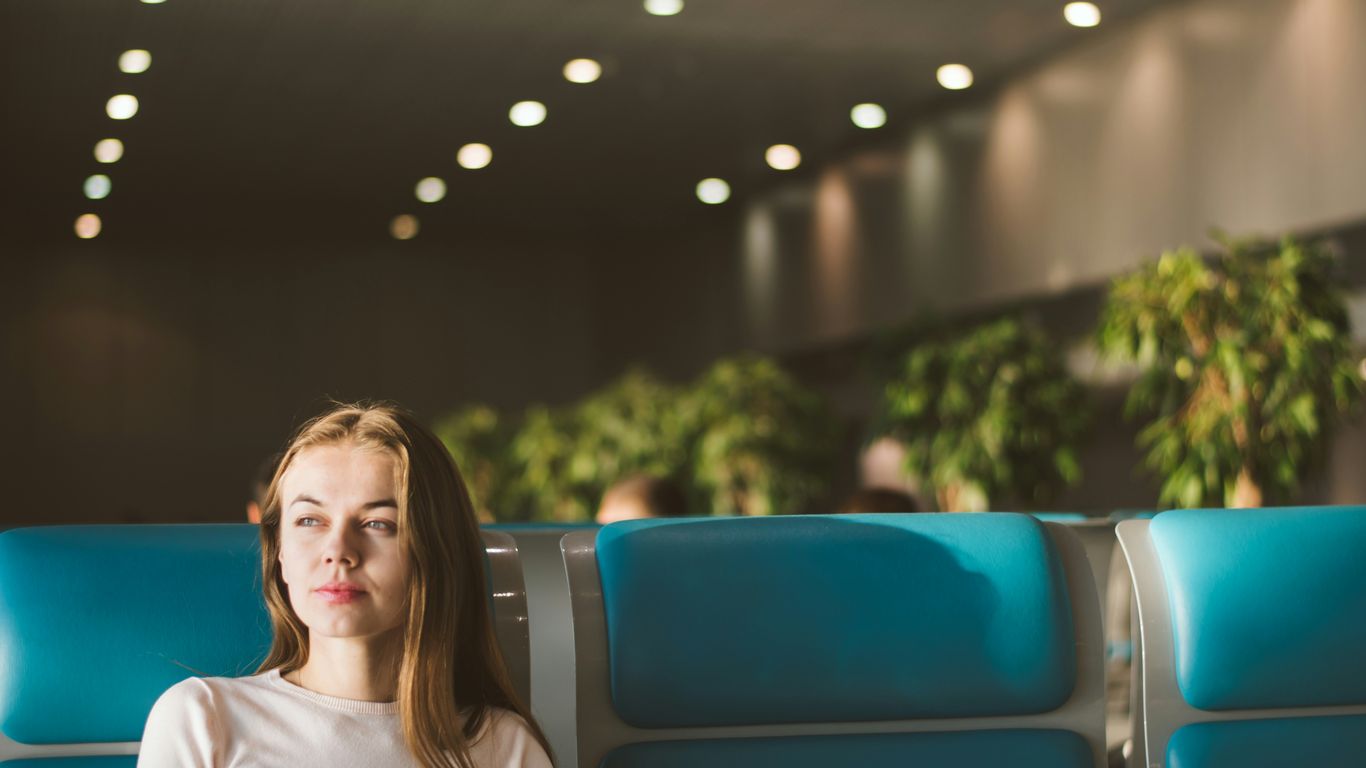 woman sitting on gray and blue gang chair