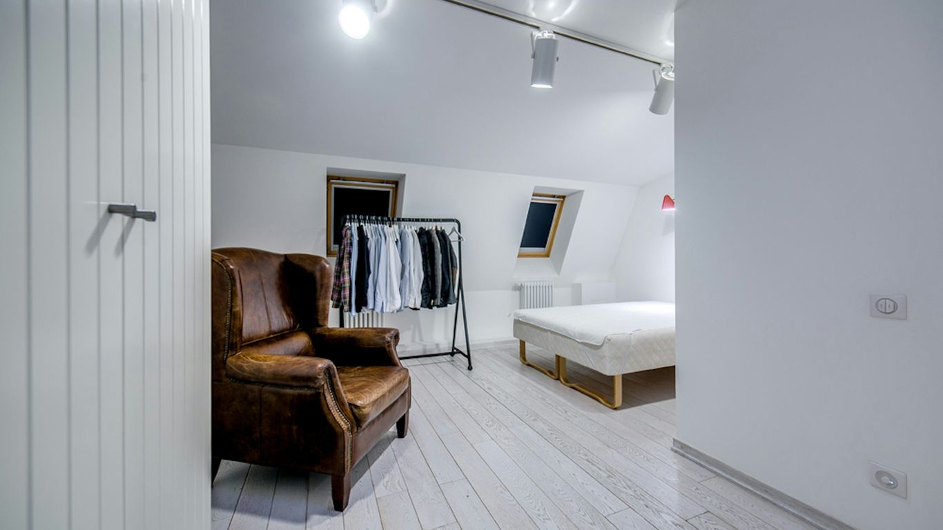 a room with a chair and a bed in it