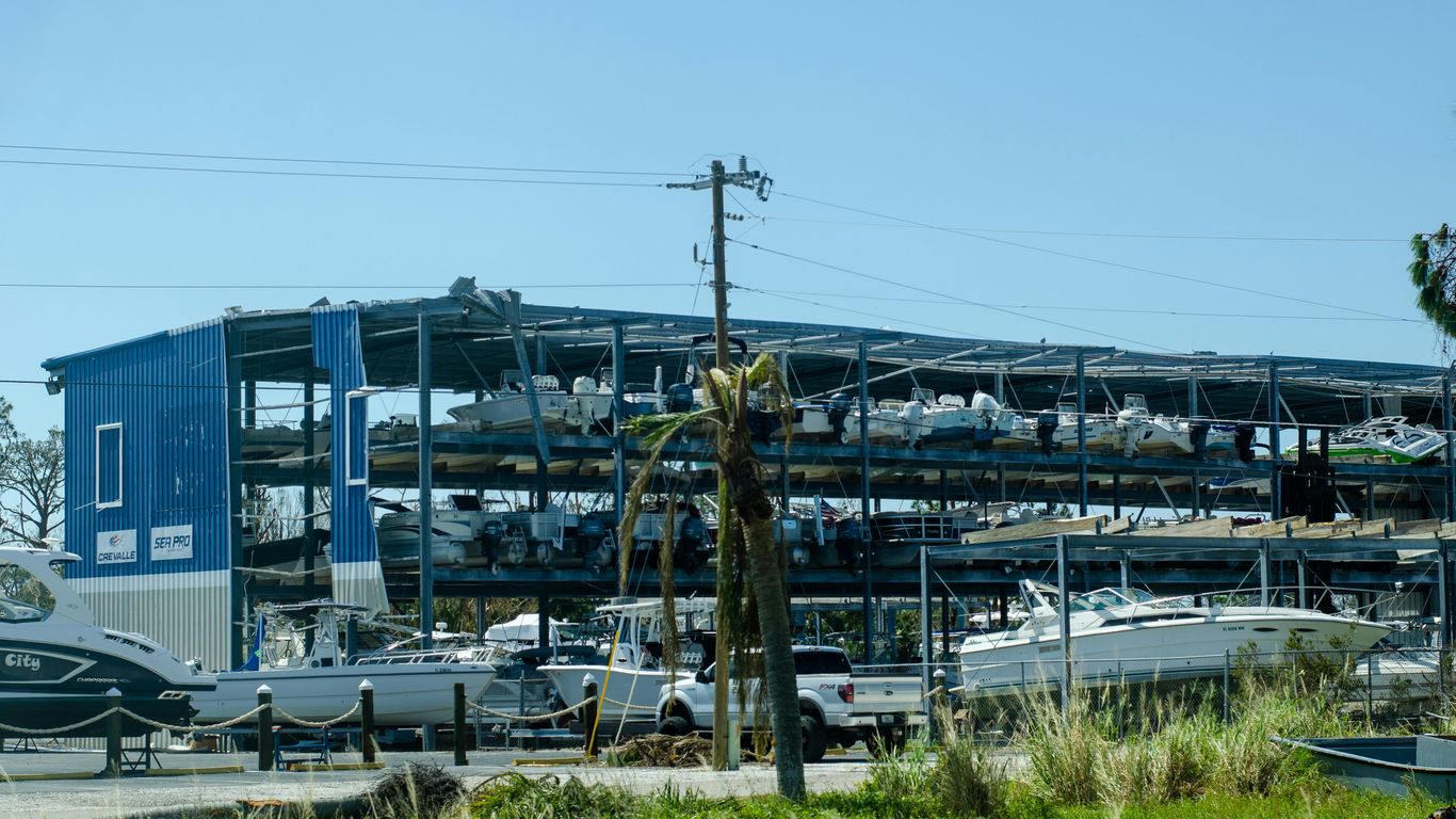 a boat yard with boats and a large building
