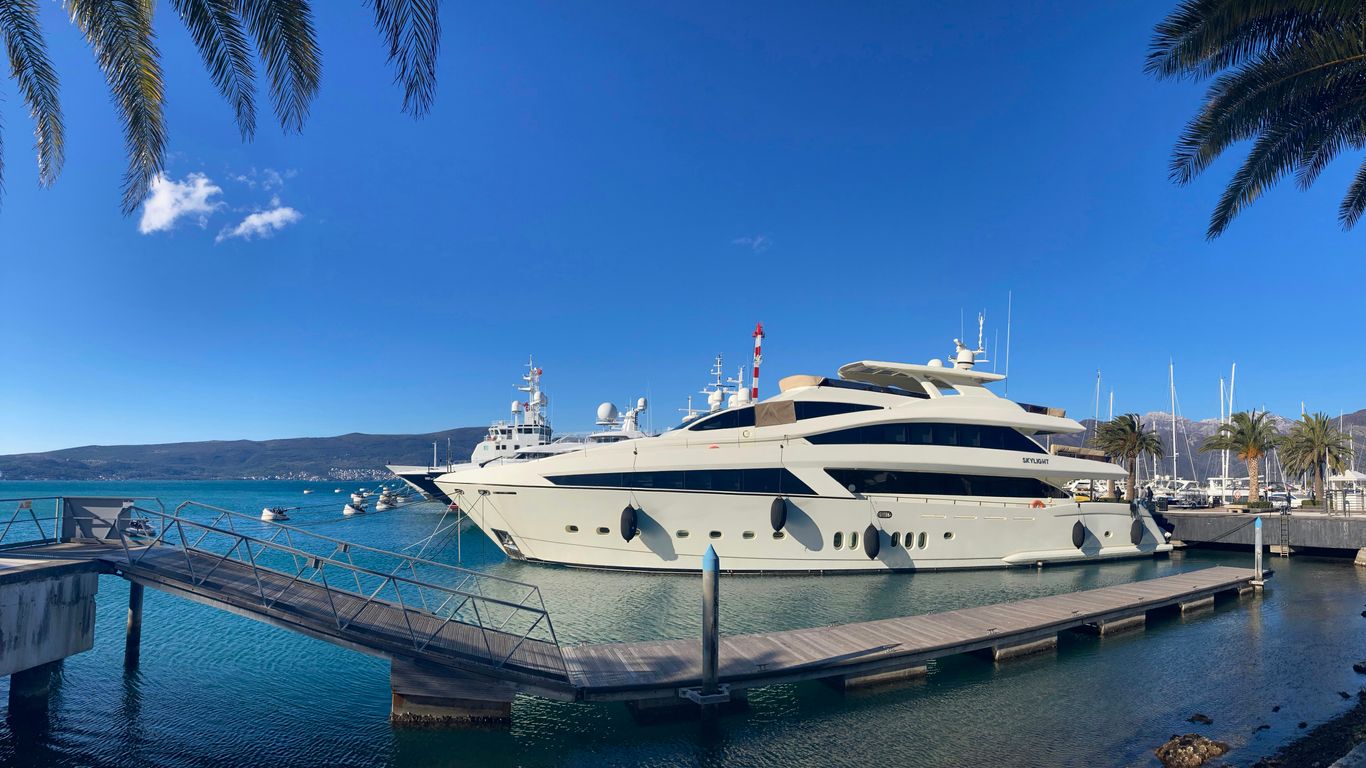 a large white boat docked at a dock