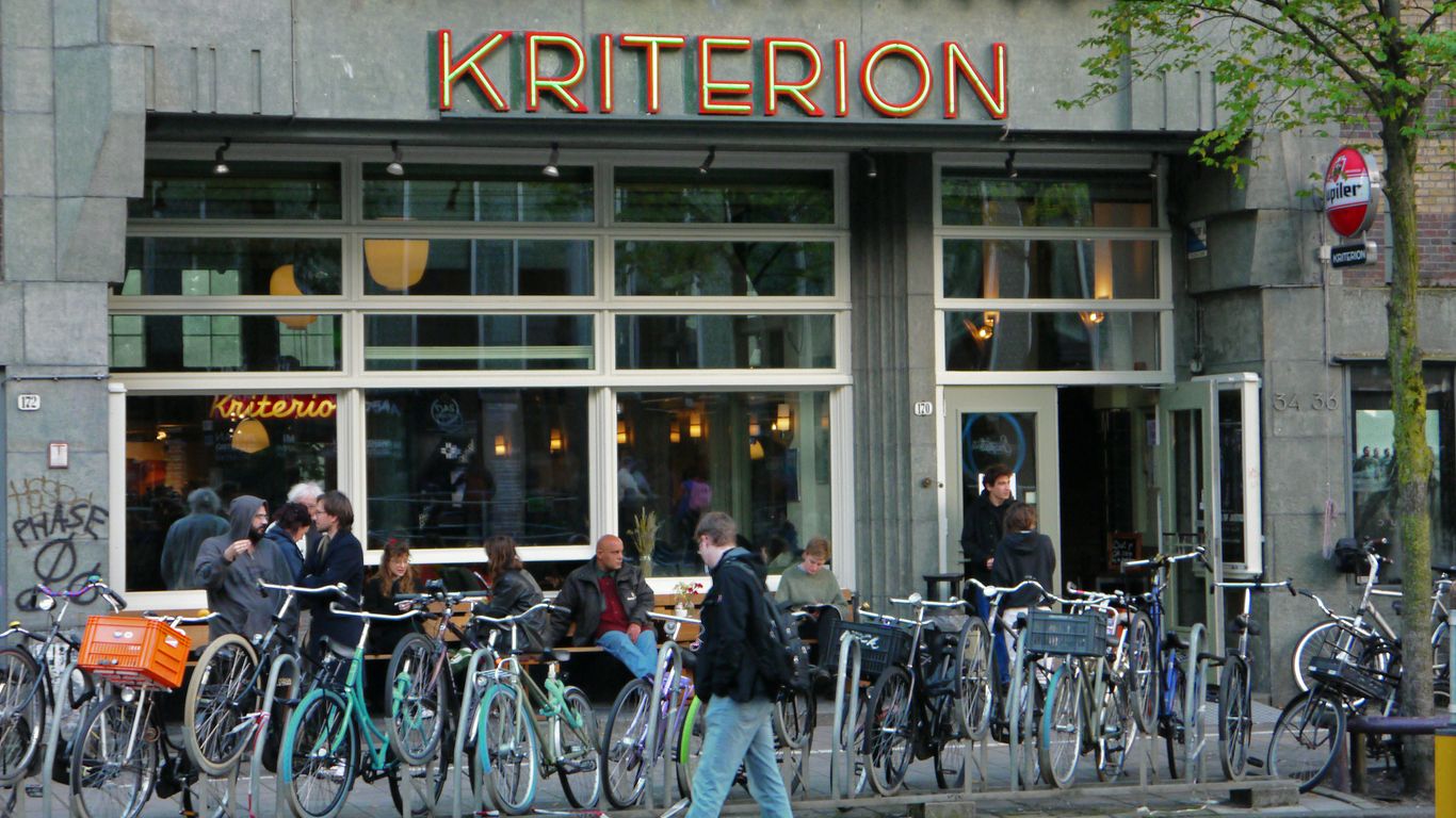 a group of people stand outside a store