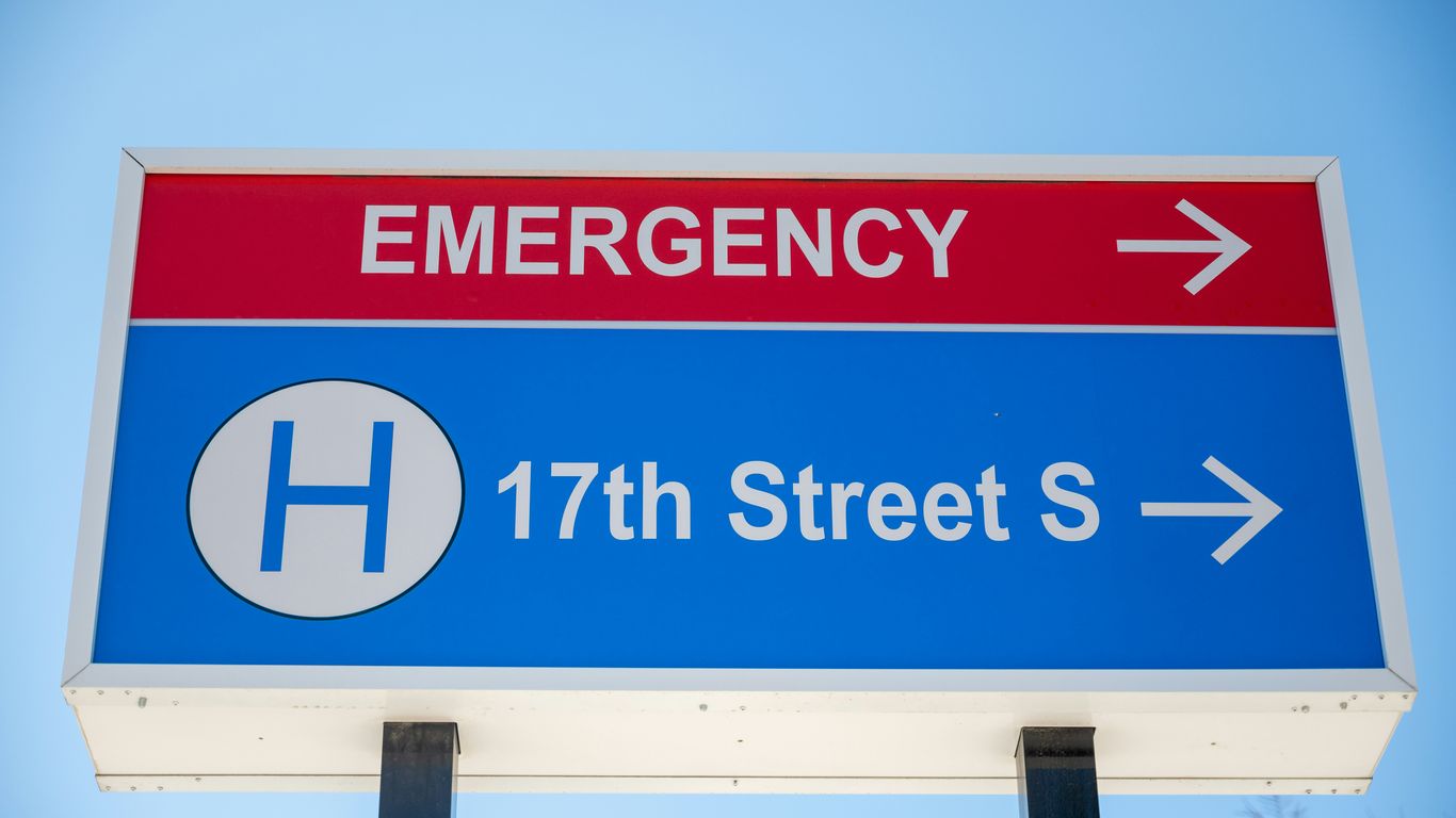 a blue and red emergency sign with an arrow pointing to the left
