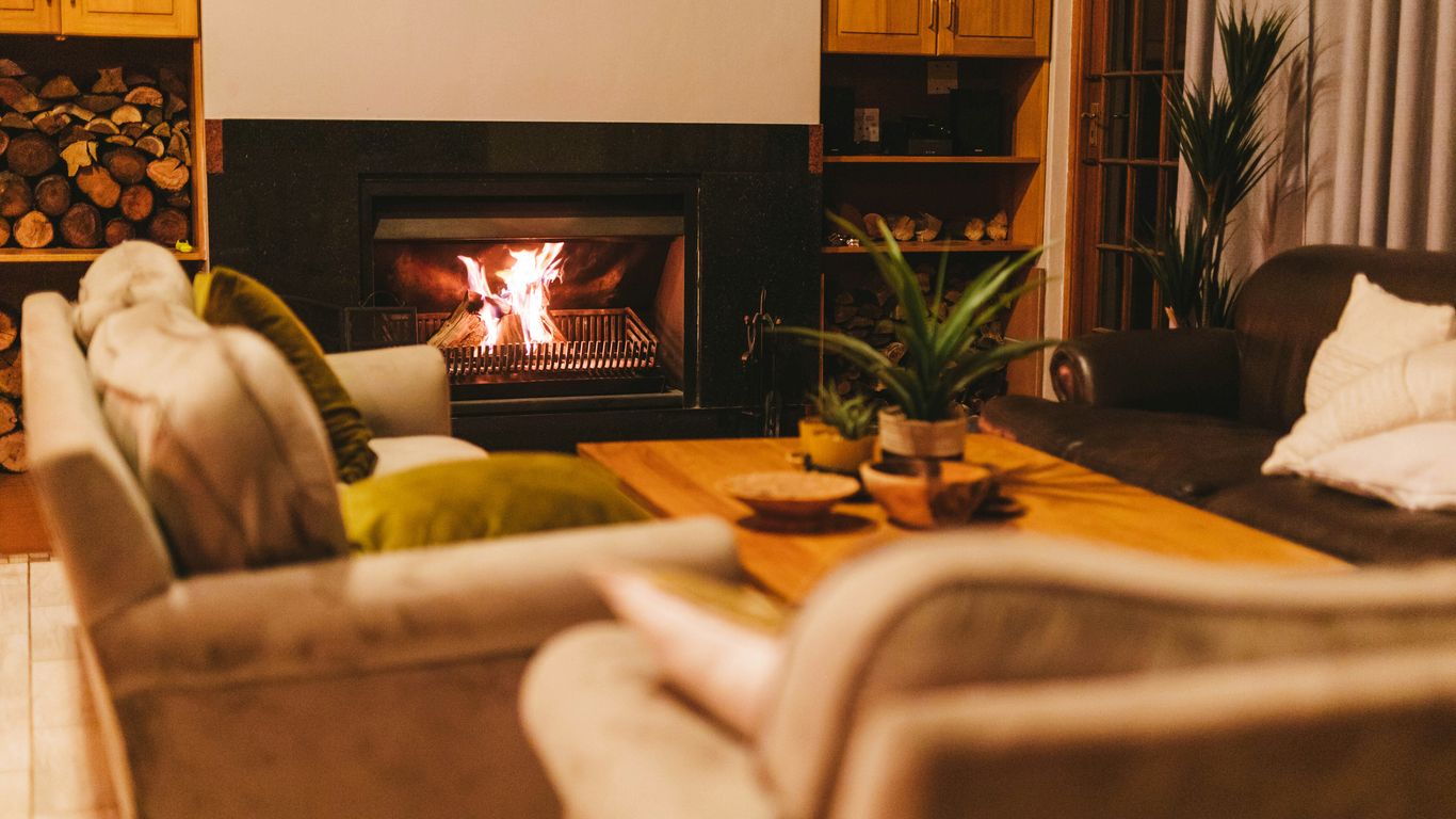 a living room filled with furniture and a fire place