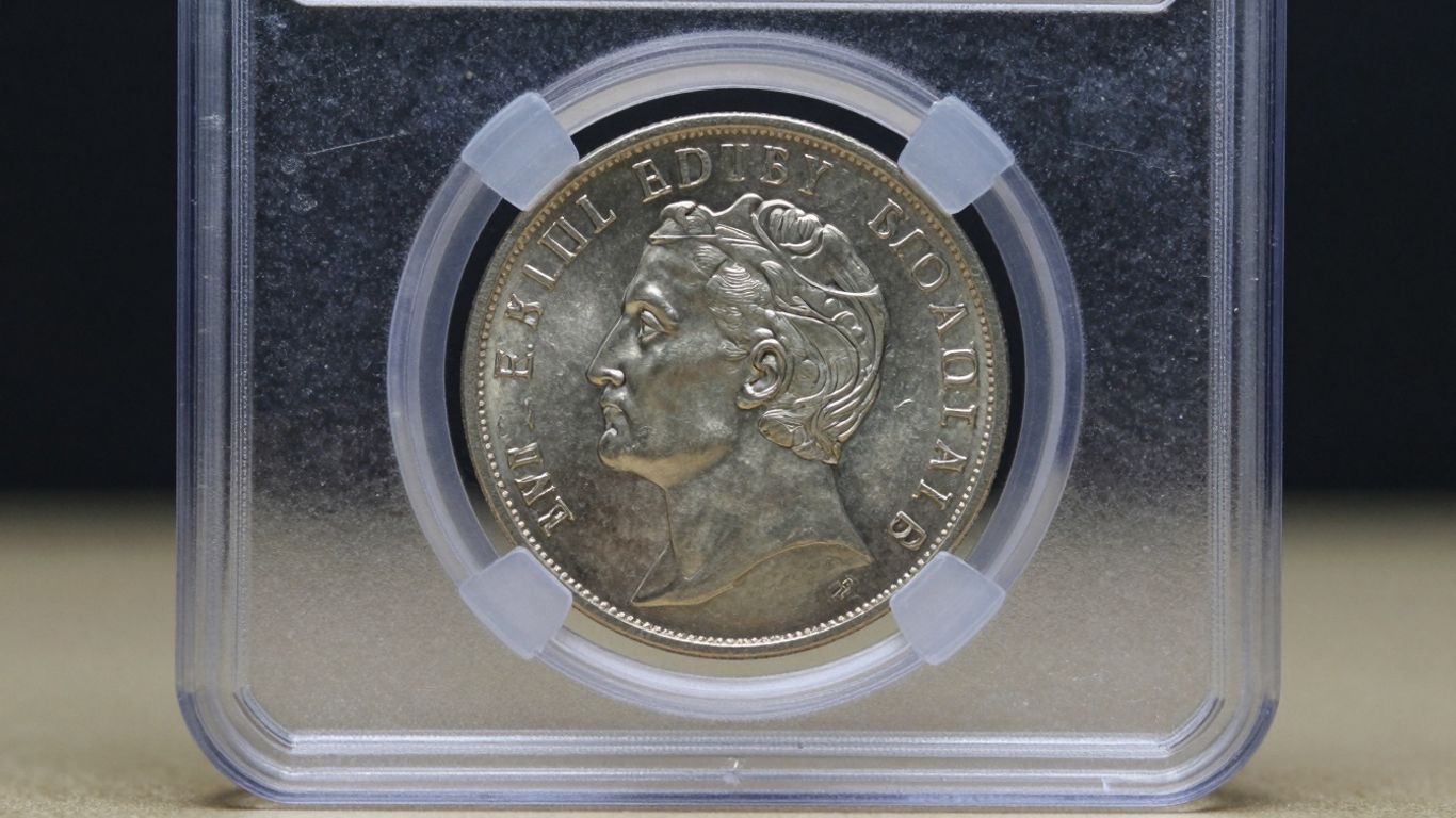 Graded coin in a clear protective slab.