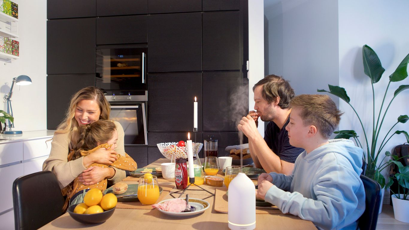 a group of people sitting around a table eating food