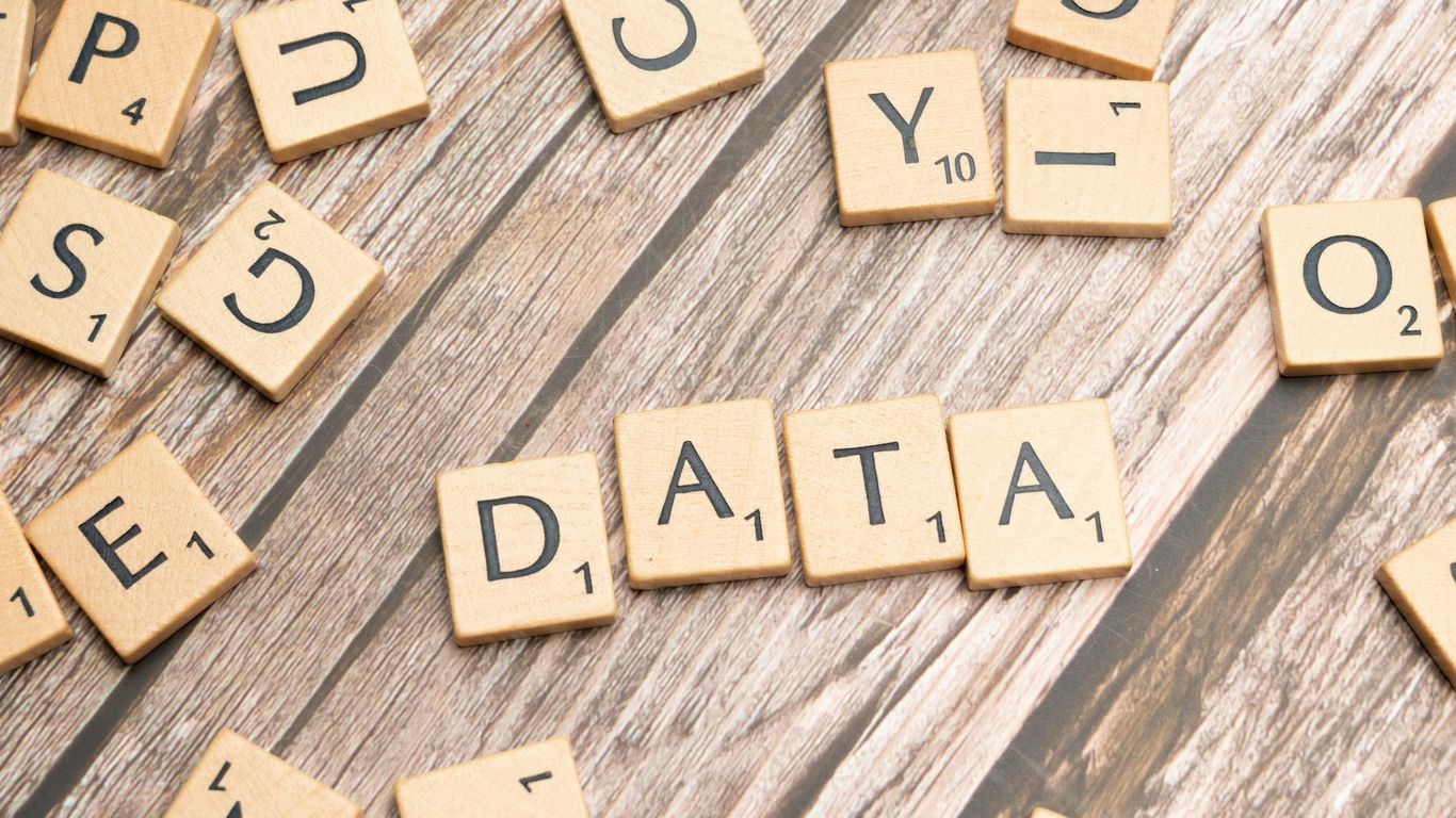 scrabble tiles spelling out the word data on a wooden surface