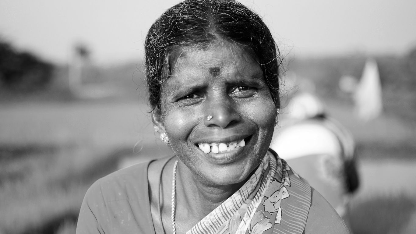 a black and white photo of a woman smiling