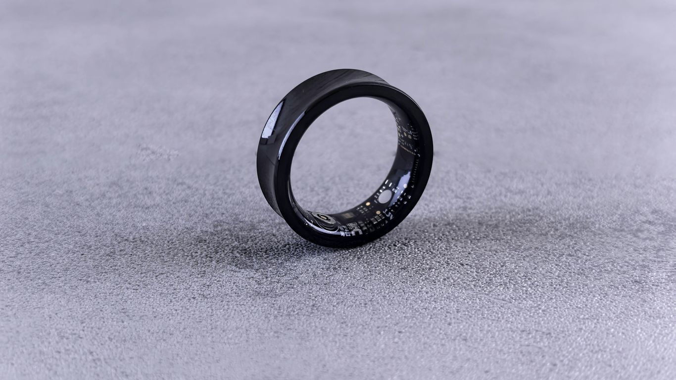 A black ring with white speckles on a gray surface