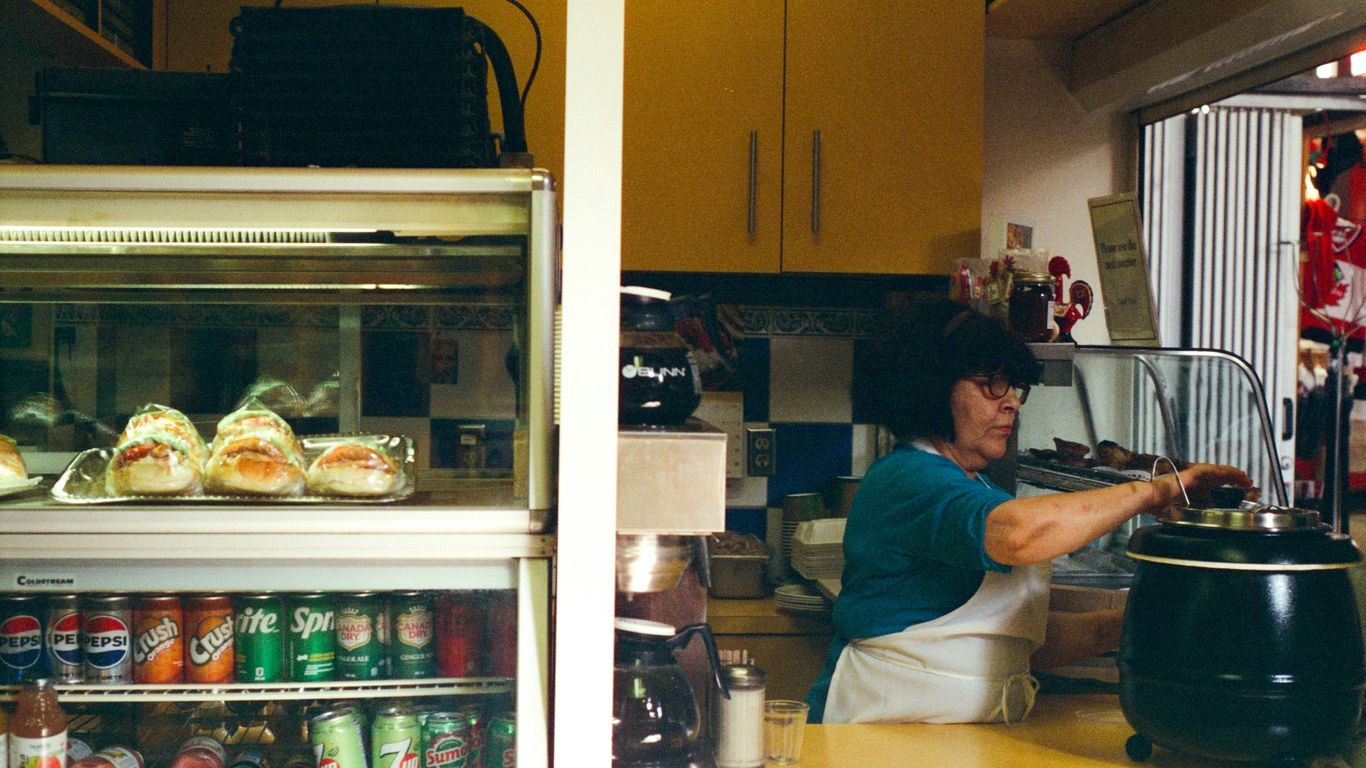 A woman prepares food behind the counter.