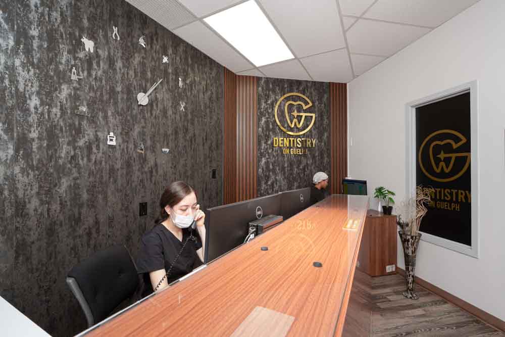 Dentistry on Guelph office reception area with a staff member on the phone.