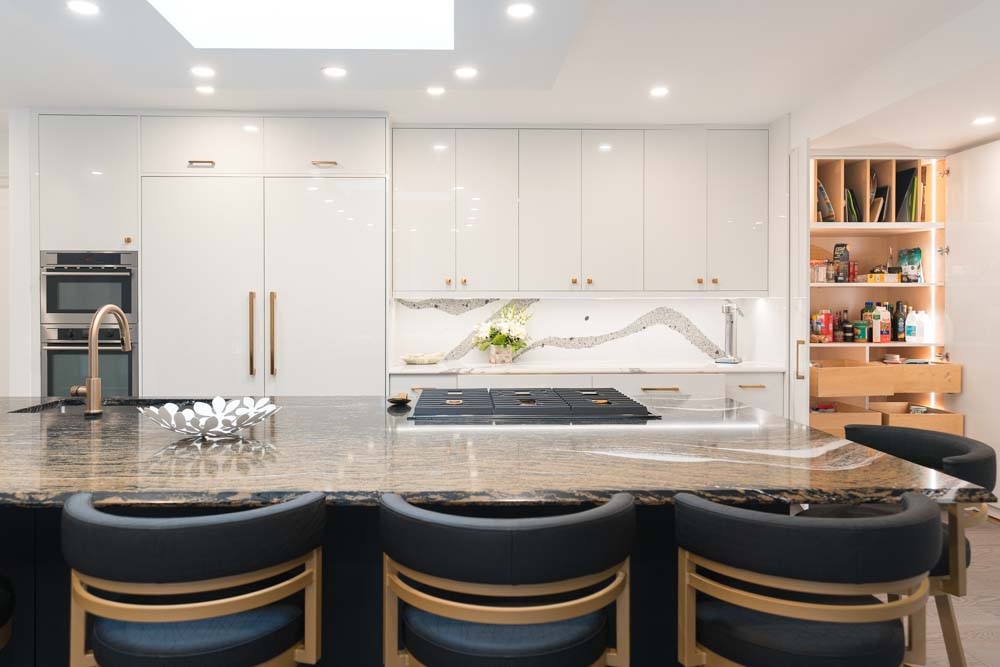 A detailed blueprint of a custom kitchen layout on a wooden worktable