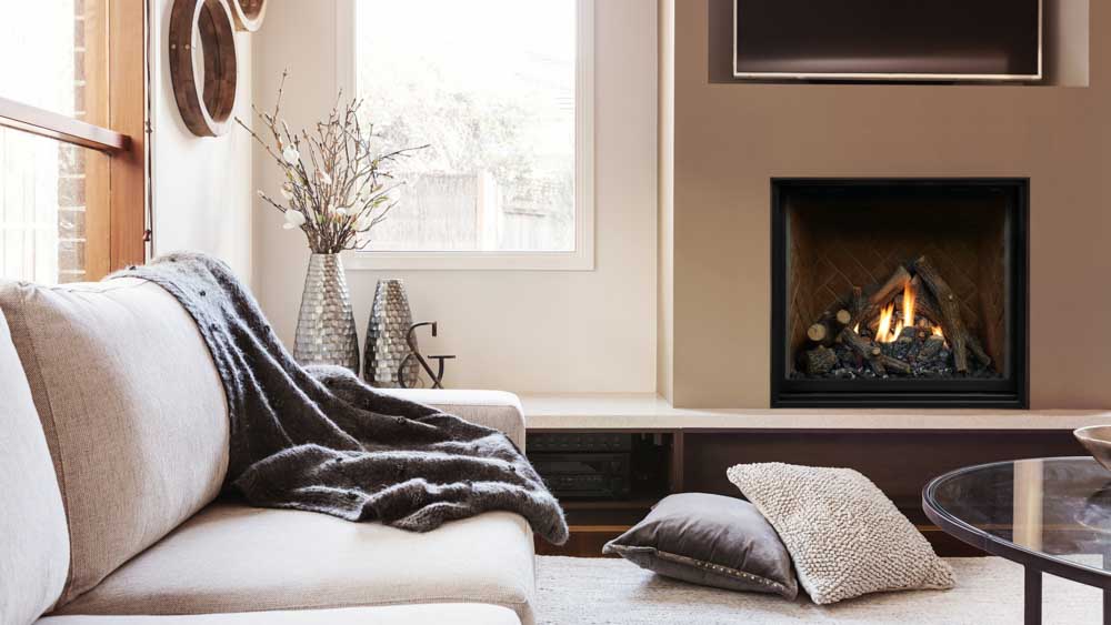 A cozy living room with a fireplace, sofa, and coffee table.