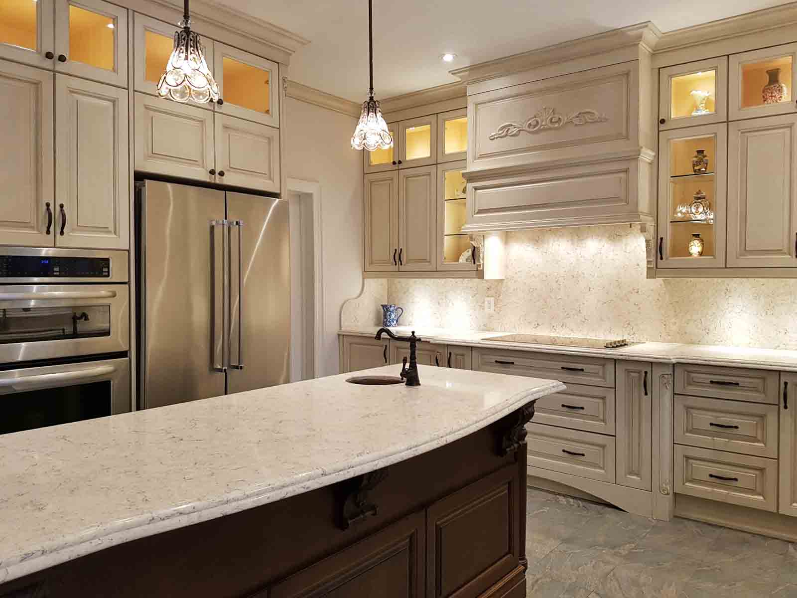 A luxurious kitchen with a large island, stainless steel appliances, and ornate cabinetry.