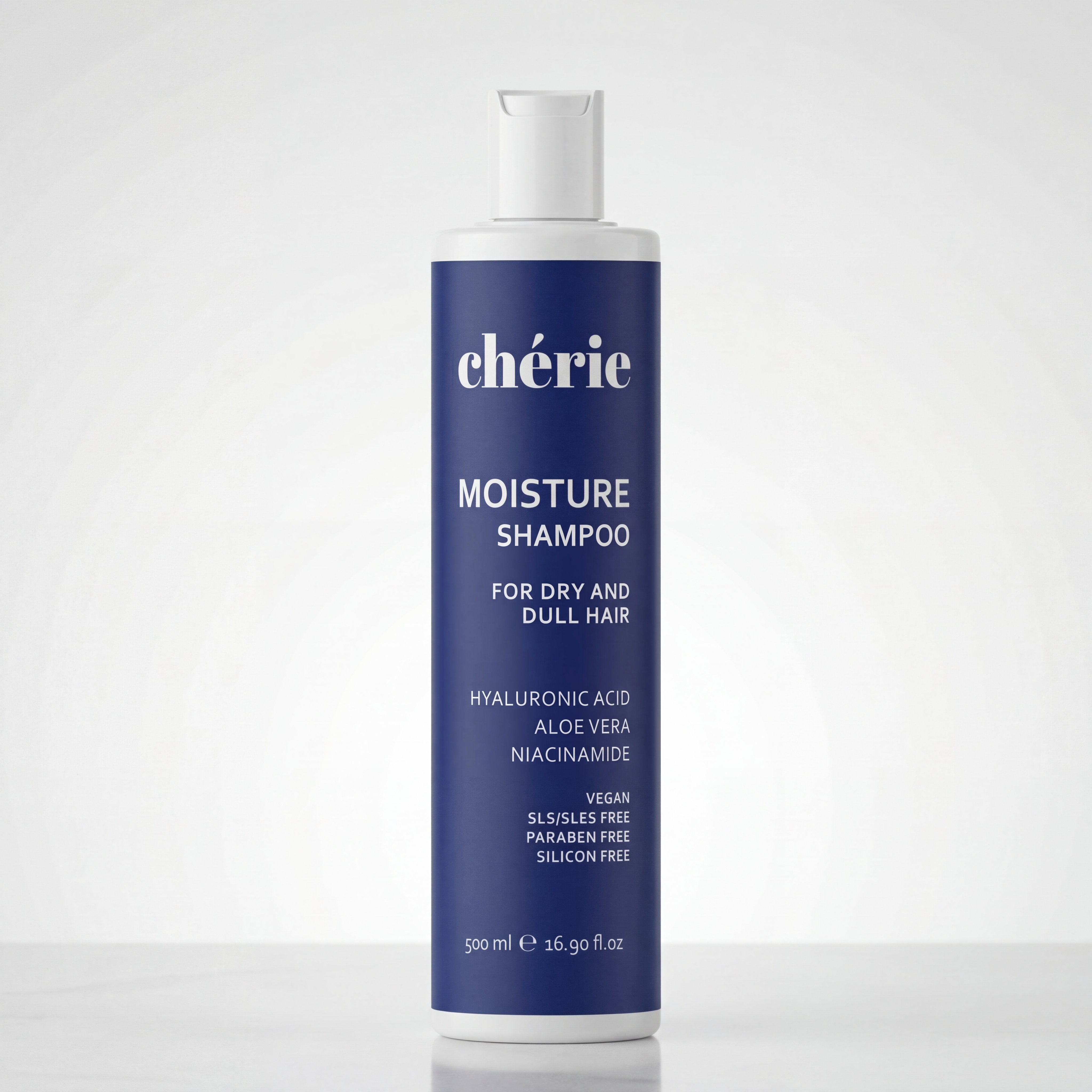 A dark blue bottle of Chérie Moisture Shampoo for dry, dull hair.