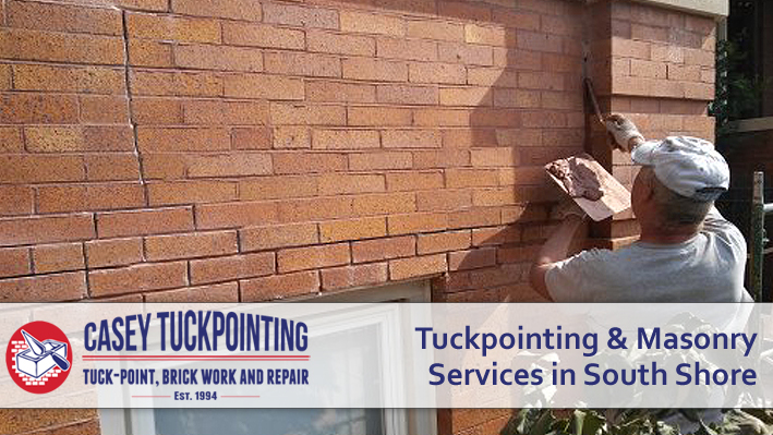 Masonry worker repairing a brick wall