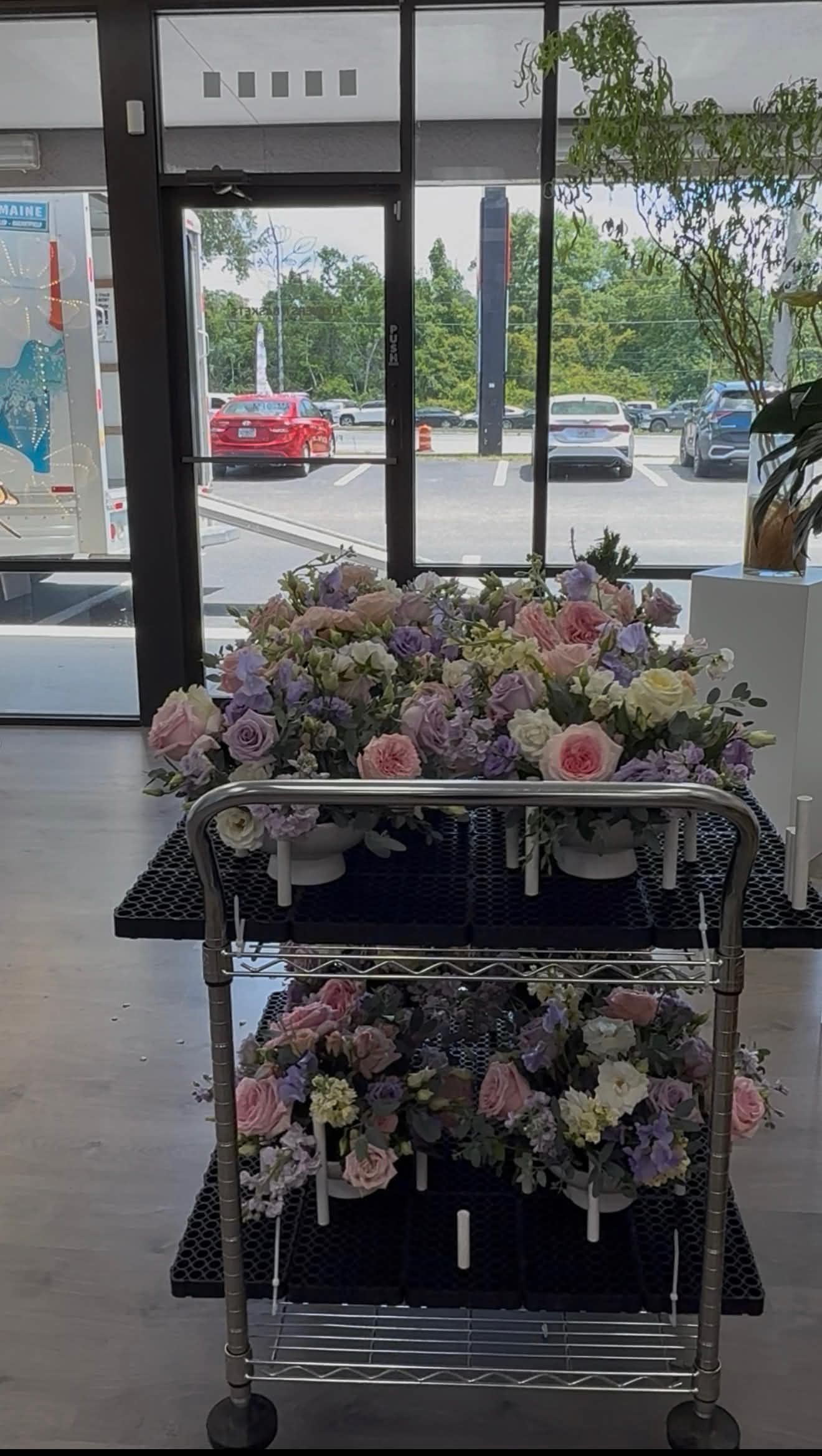 Two carts filled with beautiful floral arrangements inside a store.