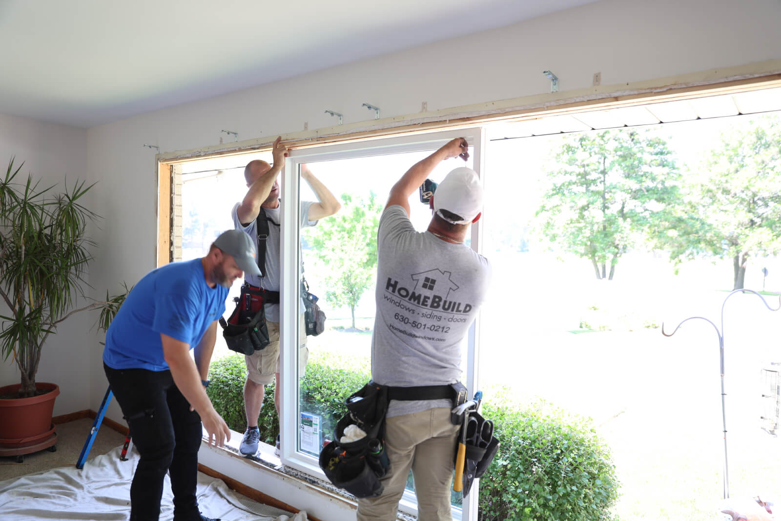Workers installing a new window in a home