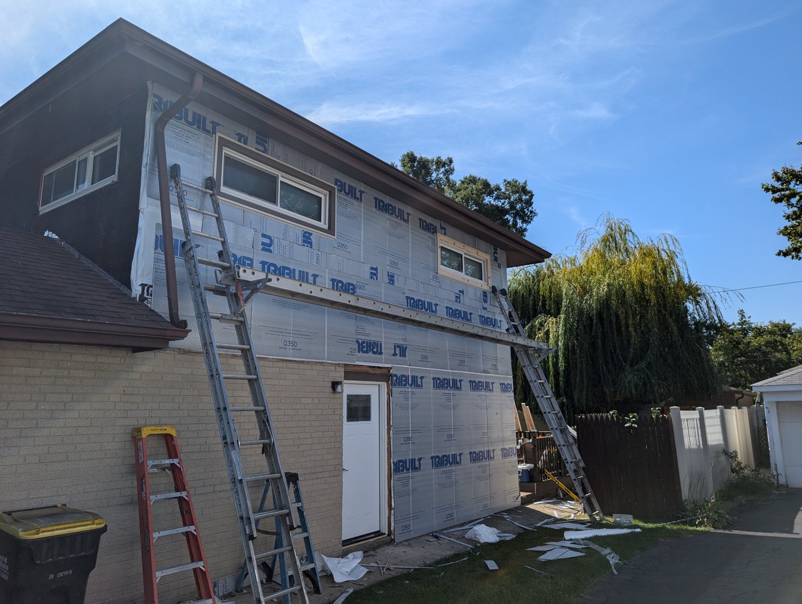 House exterior undergoing siding renovation with professional care