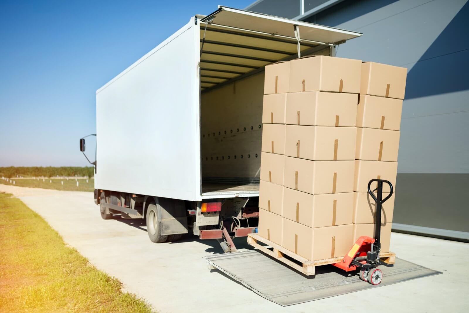 Boxes stacked on a pallet are being loaded into a truck