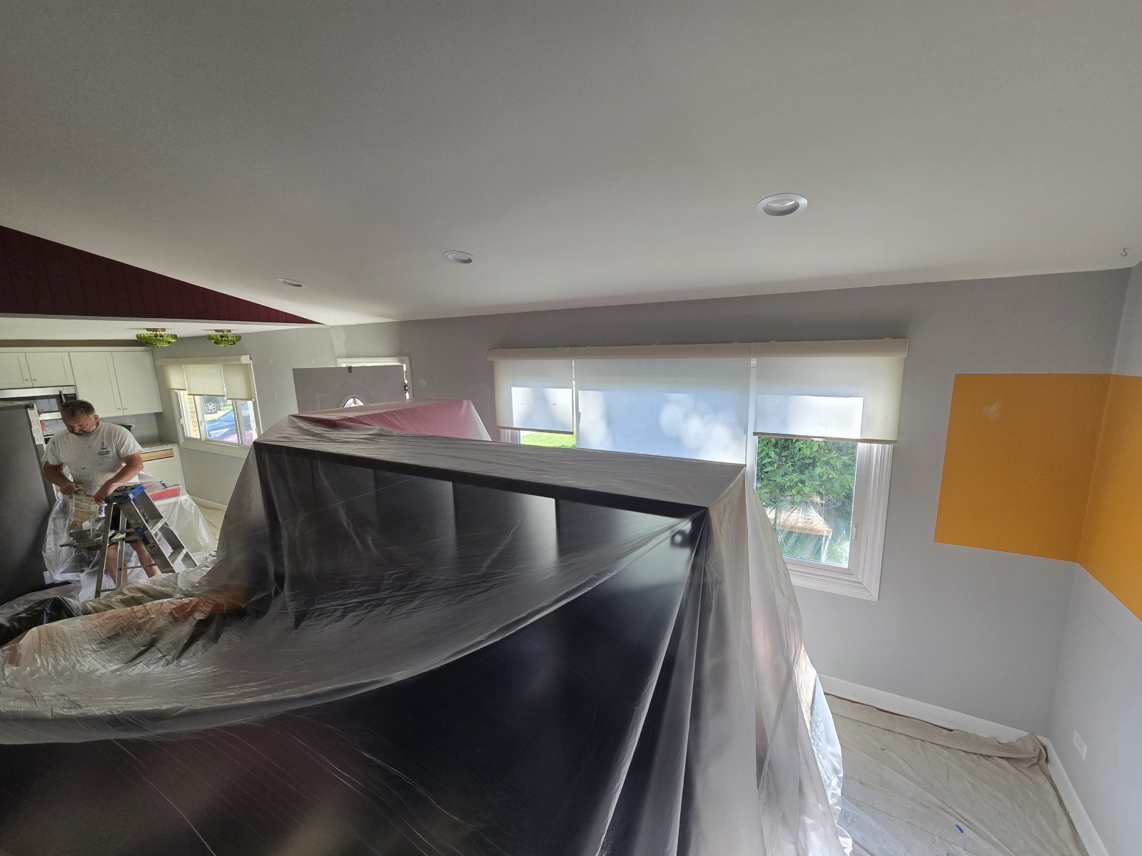 A person prepares a wall for painting with professional tools