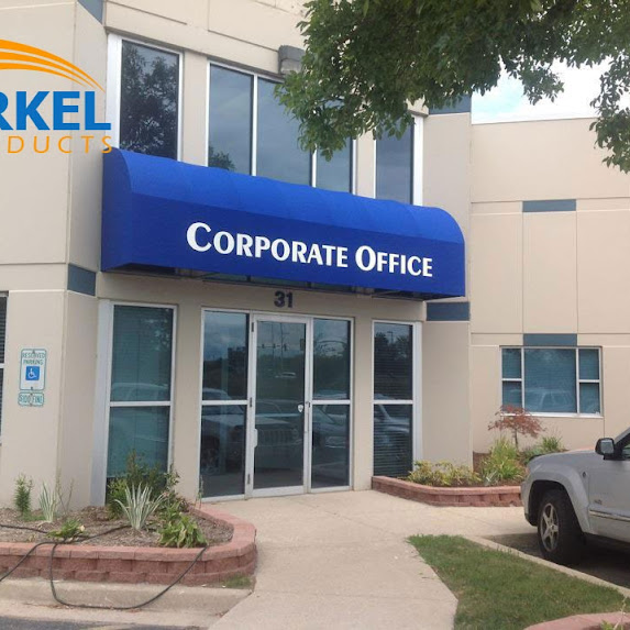 A corporate office building entrance with a blue awning
