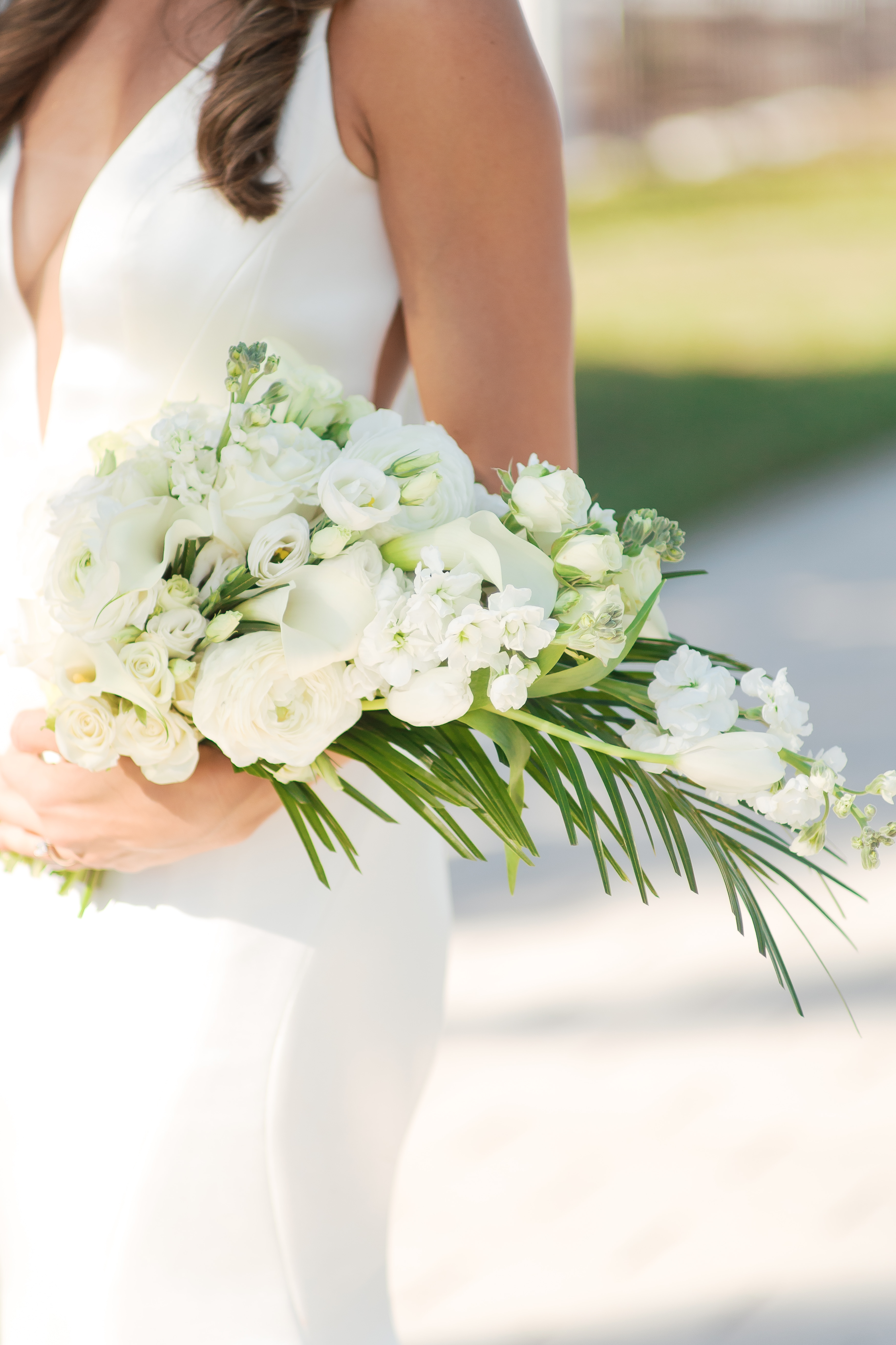 A person holds a vibrant bouquet of flowers, representing the care and craftsmanship put into each handcrafted order