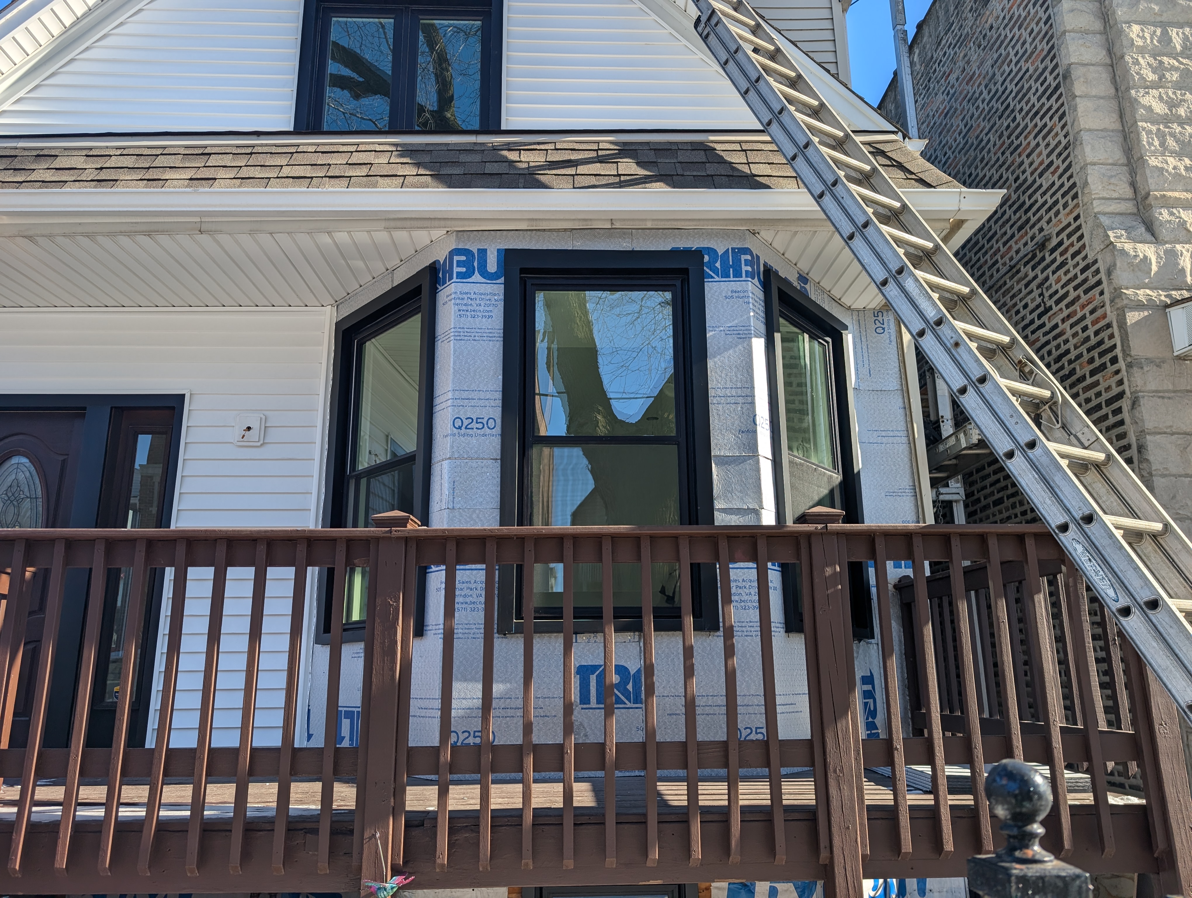 House exterior with new windows and siding under construction