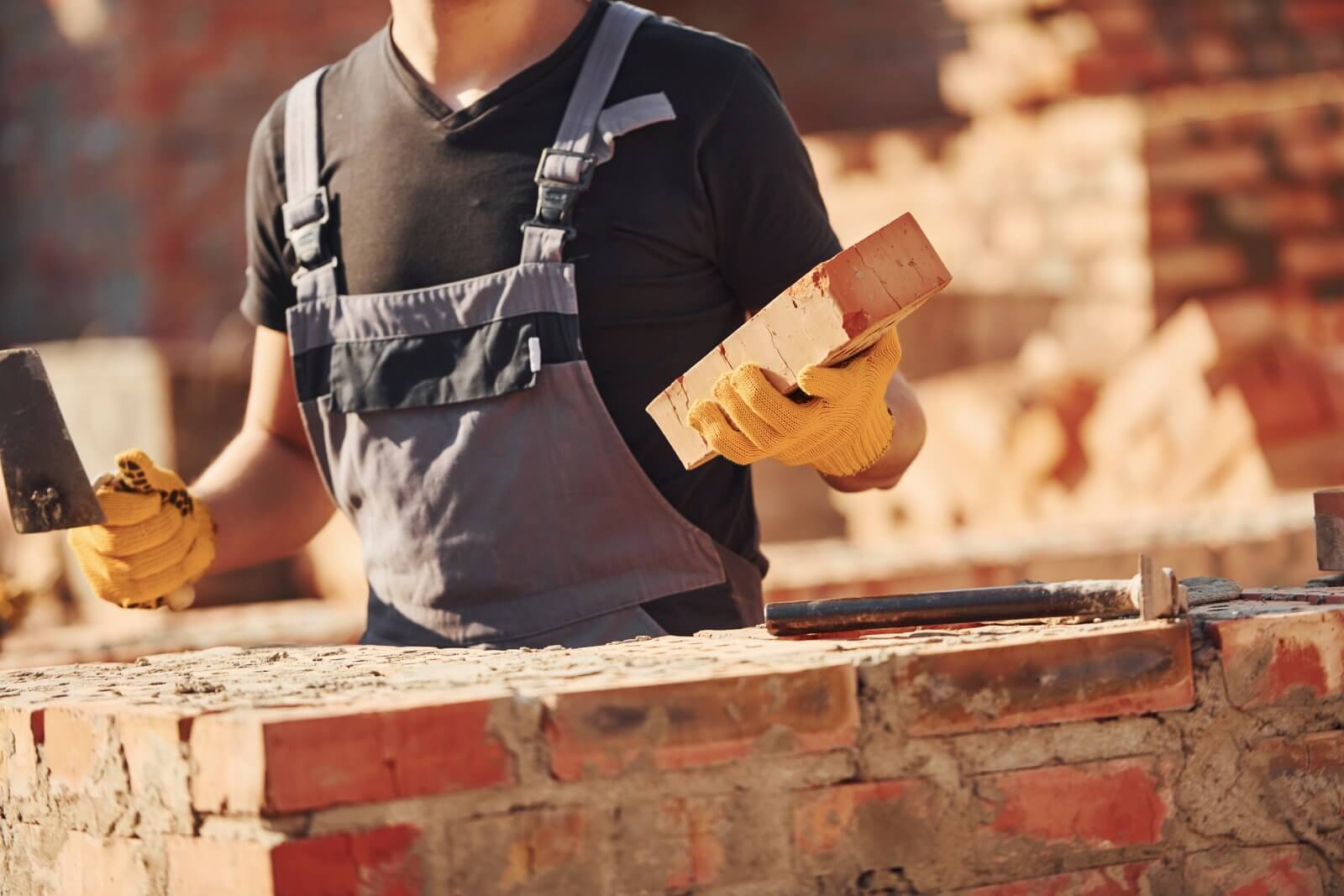 Worker performing brick wall restoration