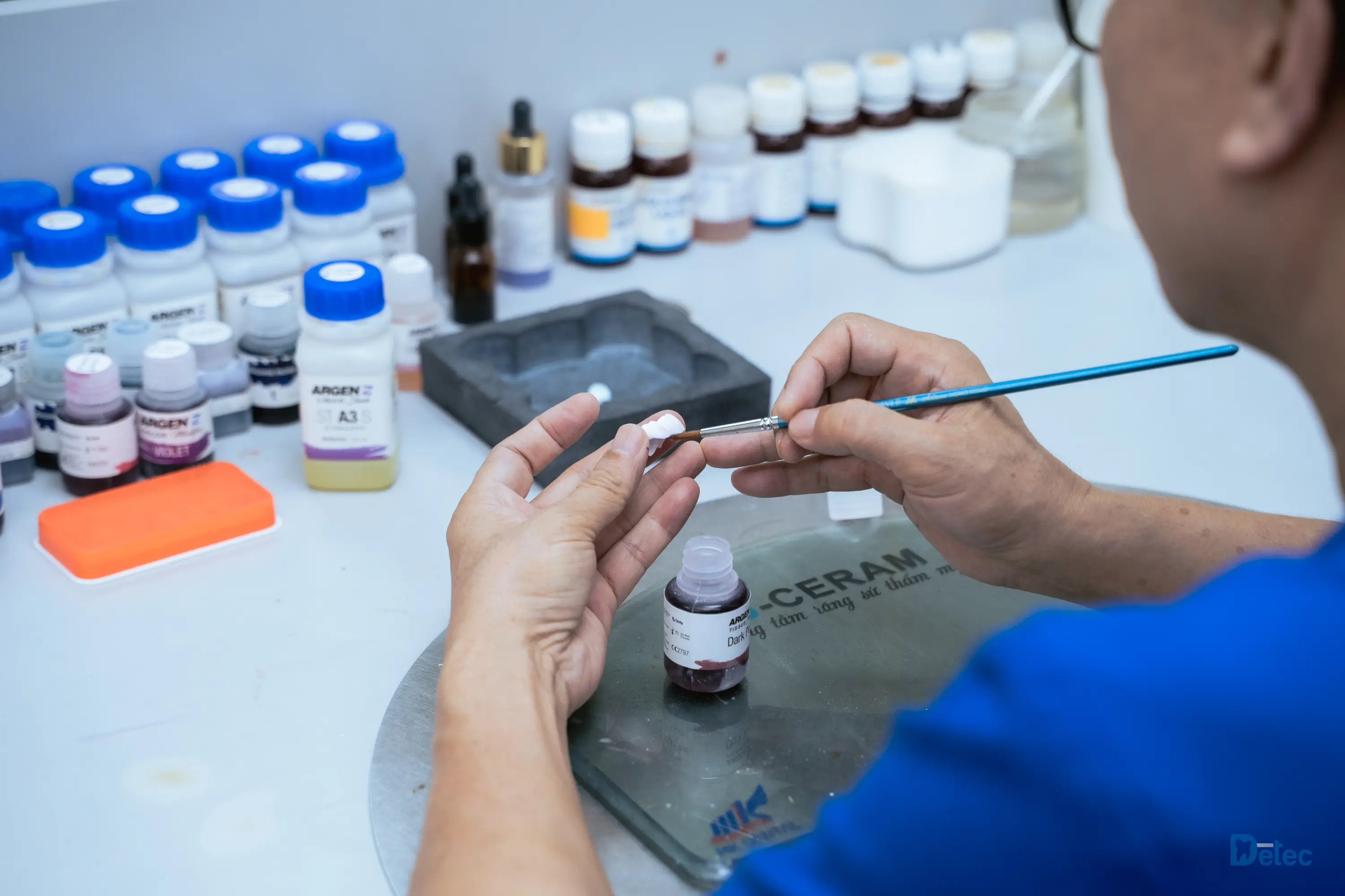 Dental technician selecting crown materials