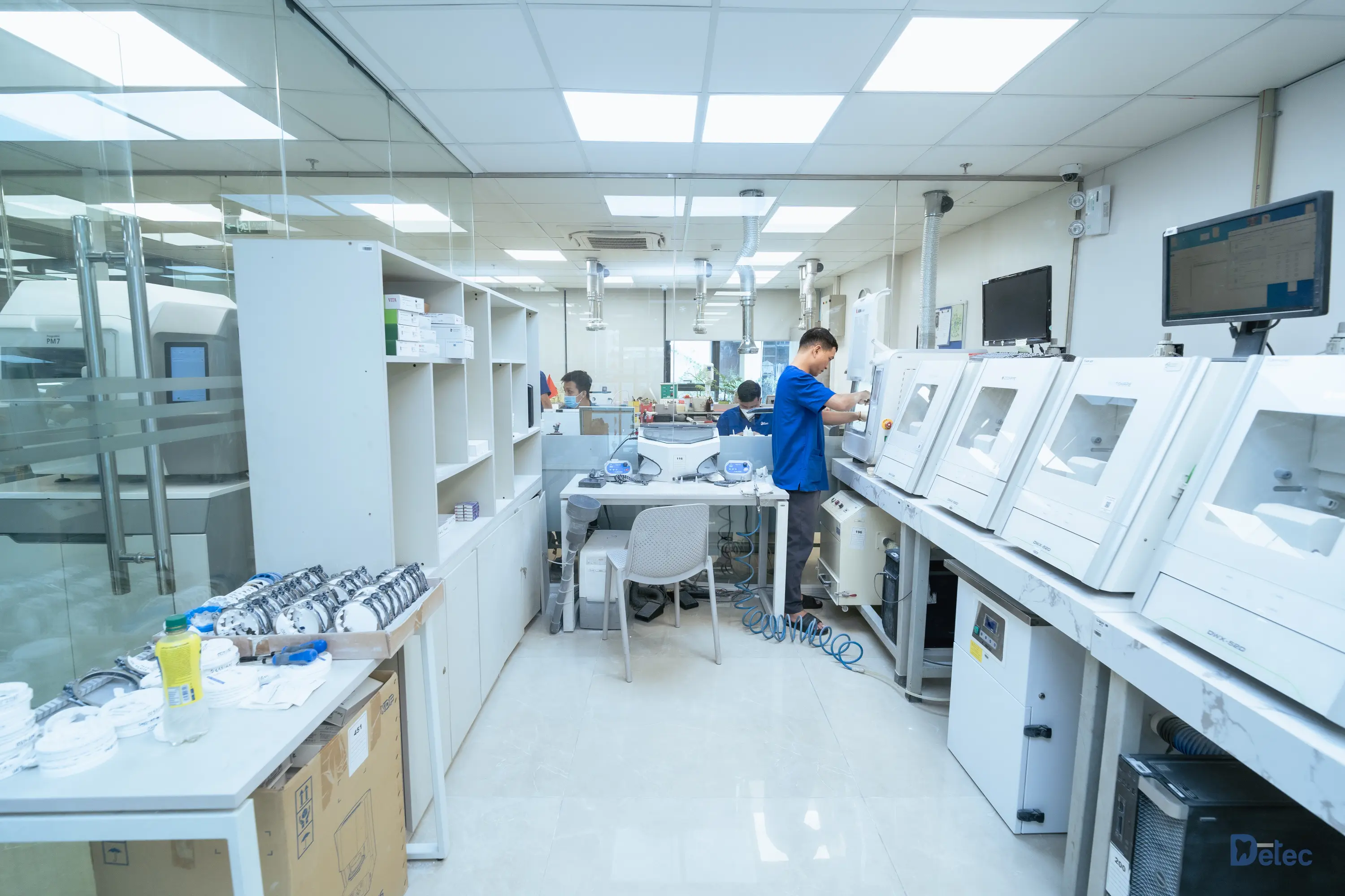 Technicians crafting customized restorations in a lab