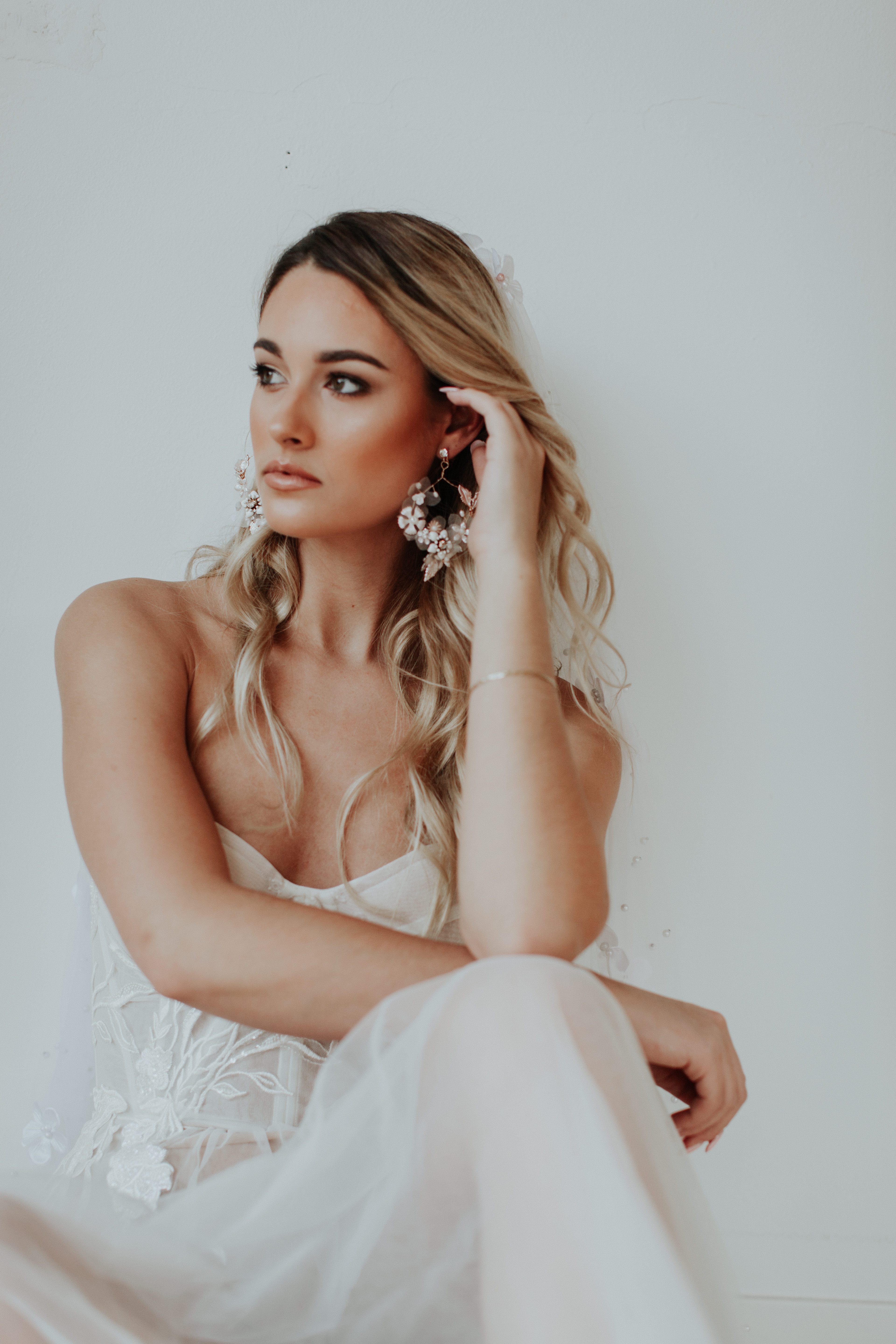 A bride with floral earrings
