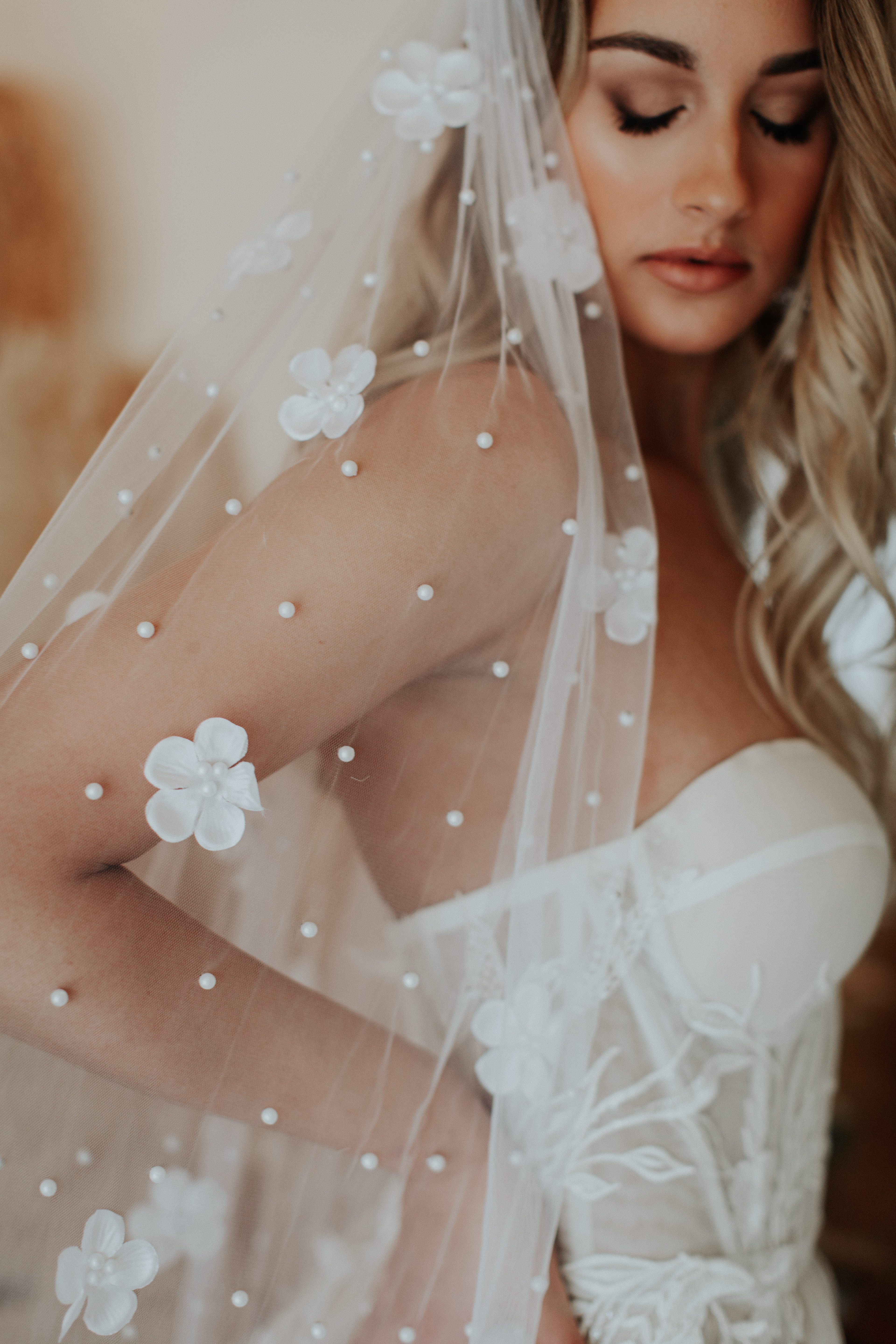 A person in a white wedding dress with a veil