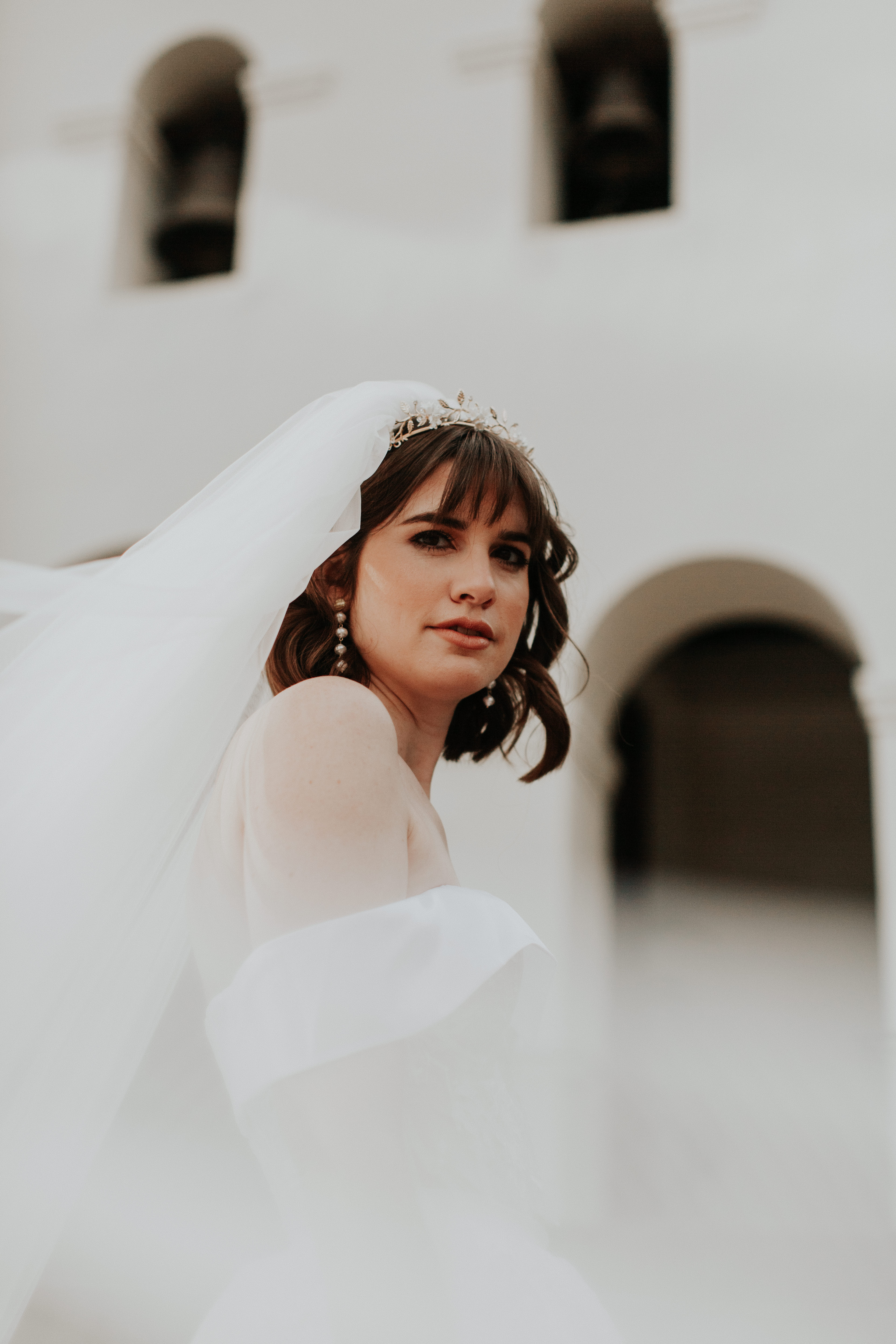 A person in a white gown and sheer veil
