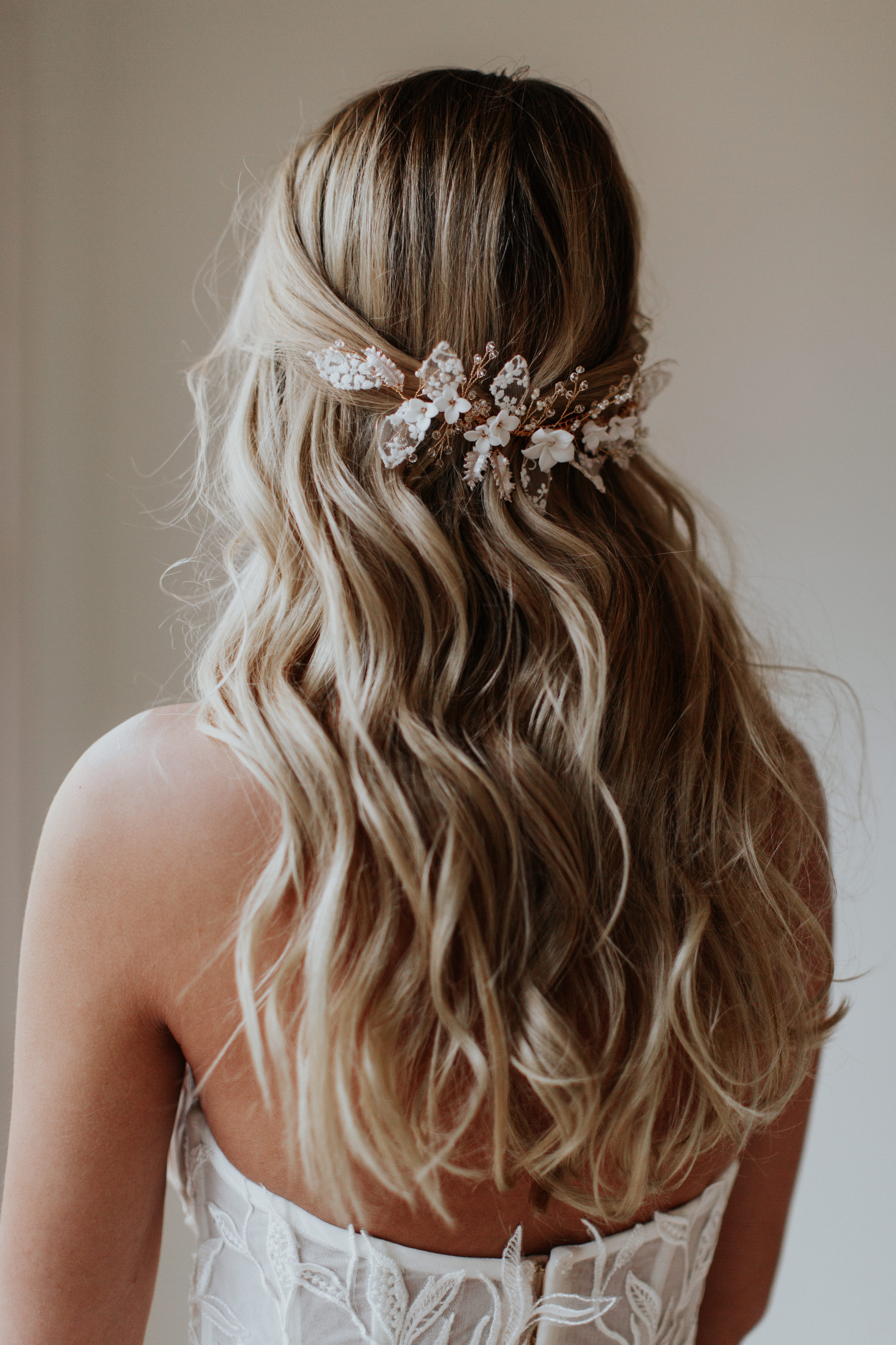 Delicate floral hairpiece in bridal updo
