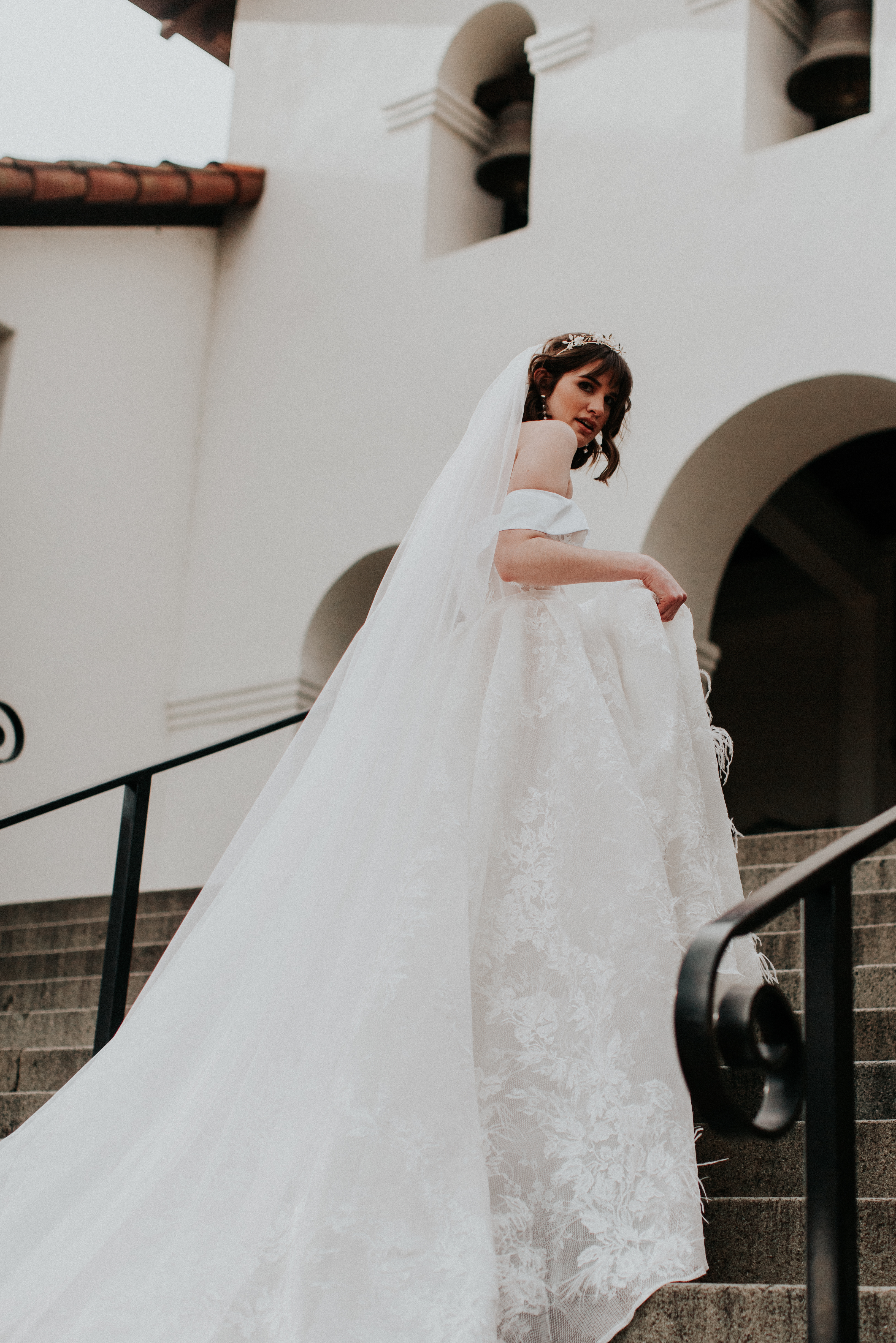 A bride in a white dress on stairs