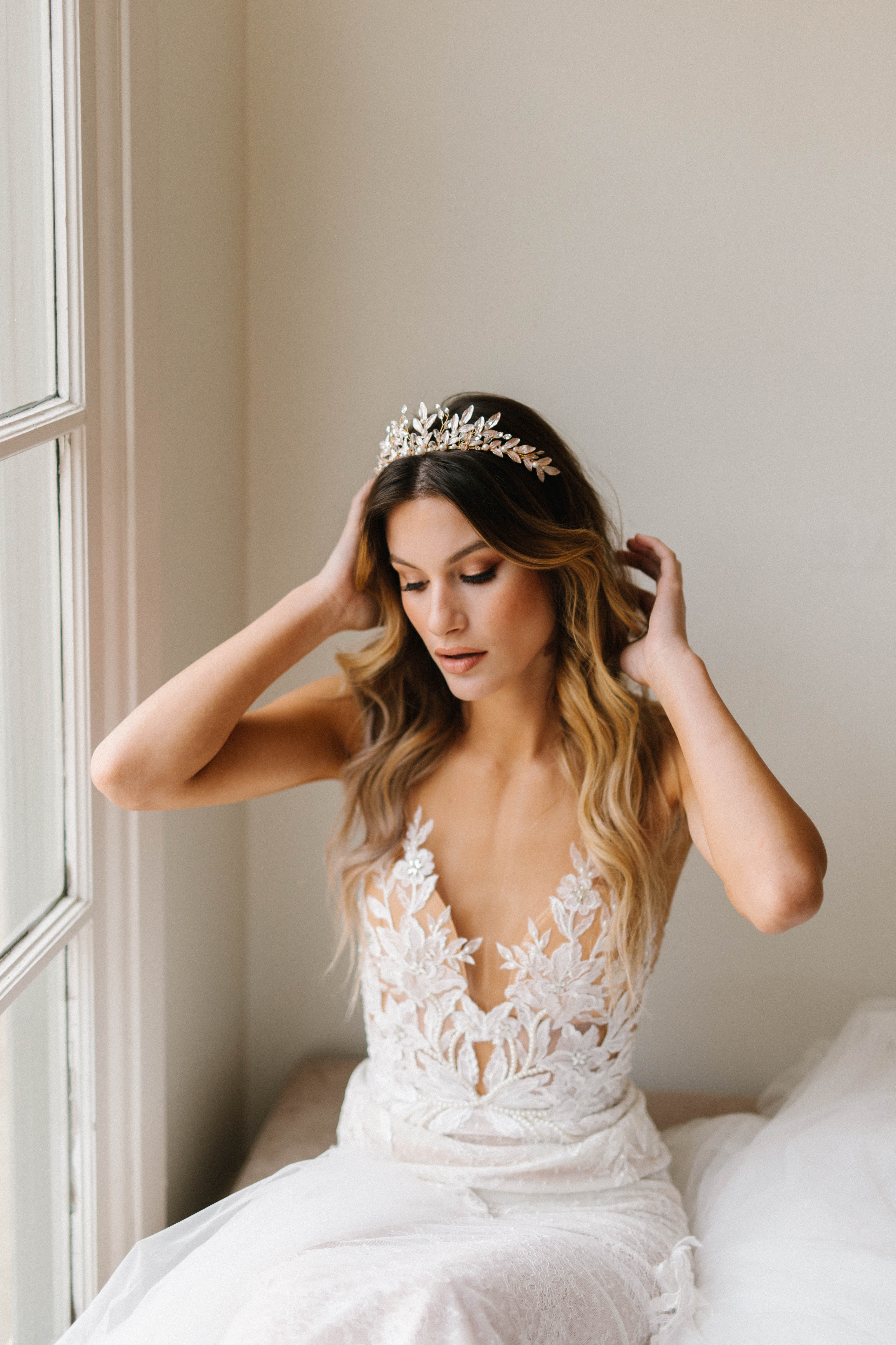 A person in a white wedding dress with a tiara
