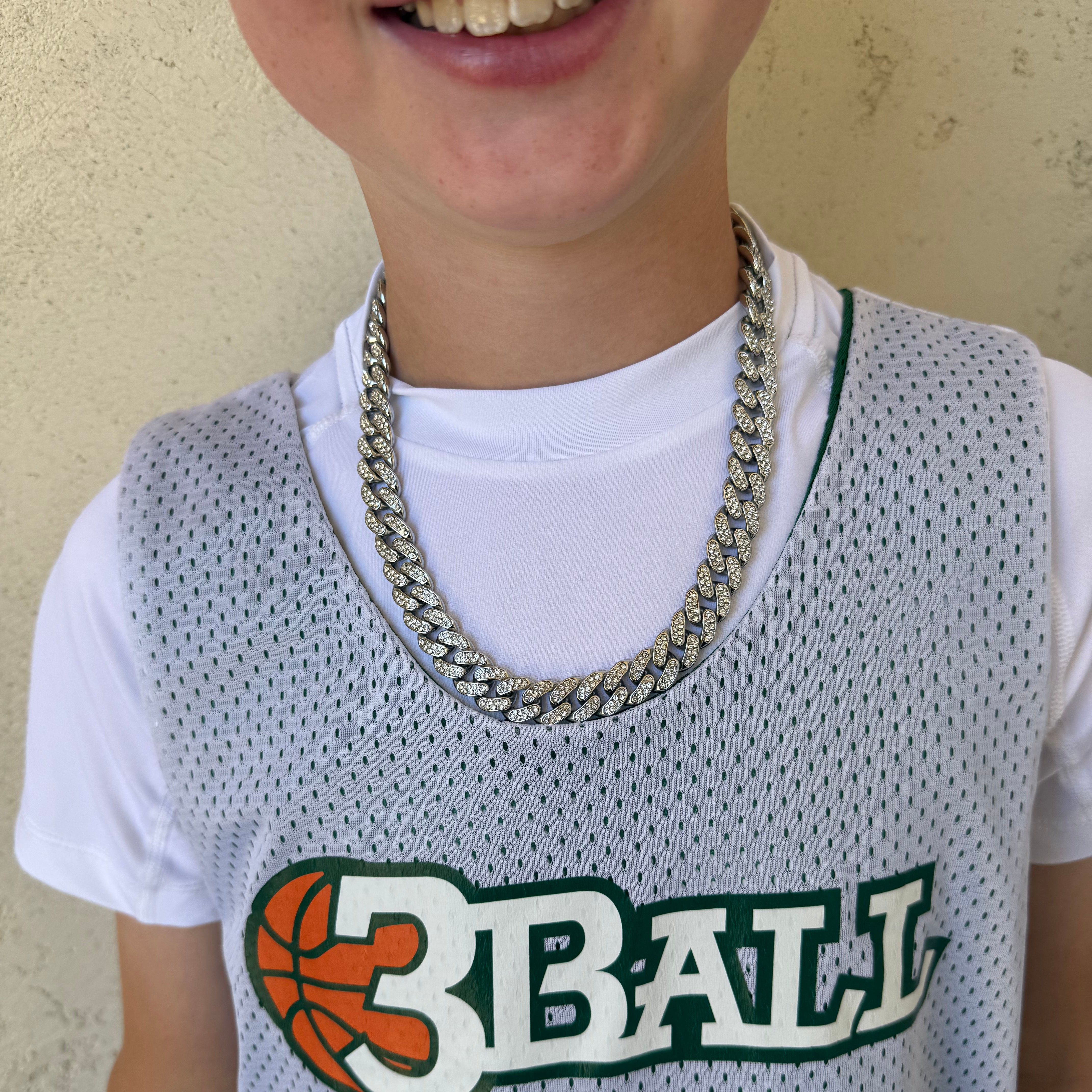 Young athlete in jersey wearing a team necklace