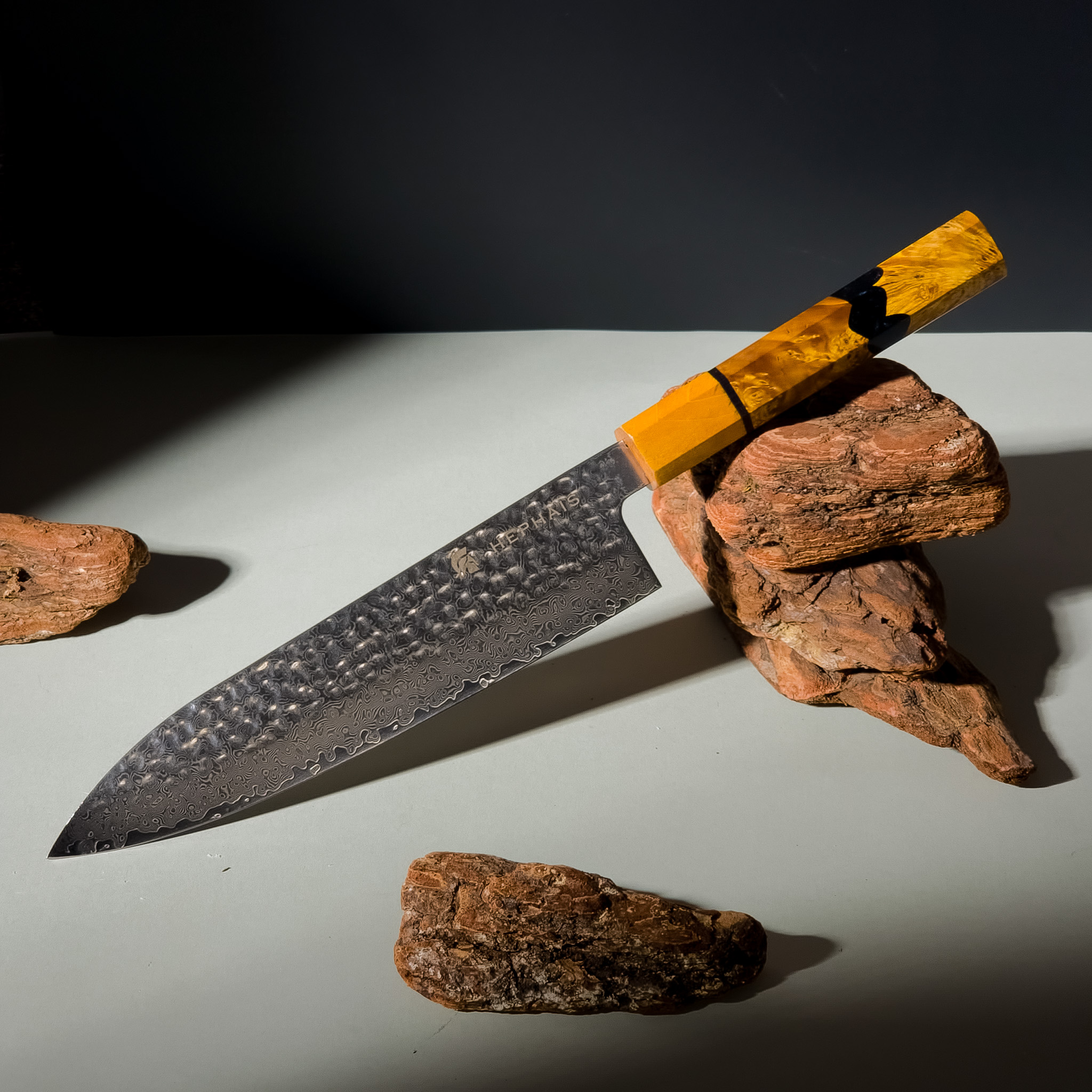 A high-end professional chef's knife resting on a rustic wooden cutting board, representing the debate of knife set vs individual knives.