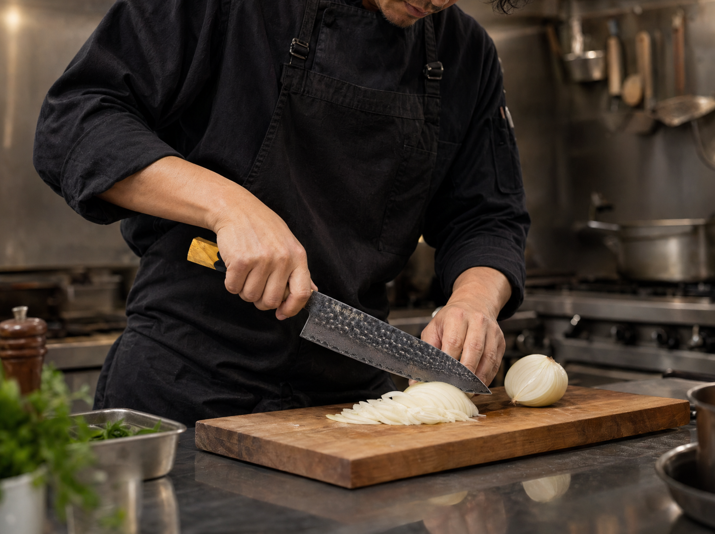 A professional chef with focused expression, expertly using a gyuto knife with a pinch grip to finely dice an onion on a dark cutting board, showcasing proper knife skills.