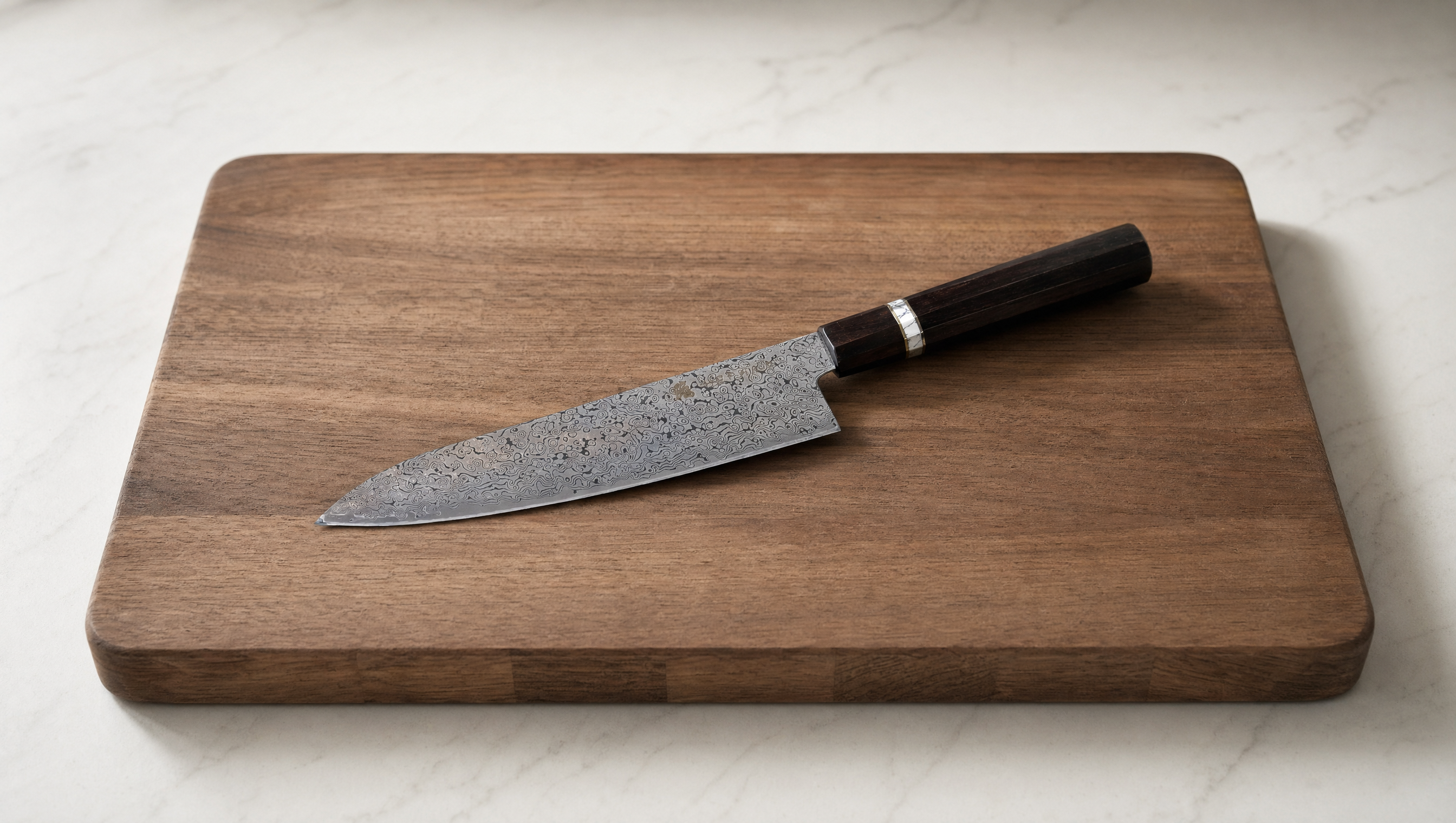 A professional Gyuto knife resting on a dark wooden cutting board, ready for use.