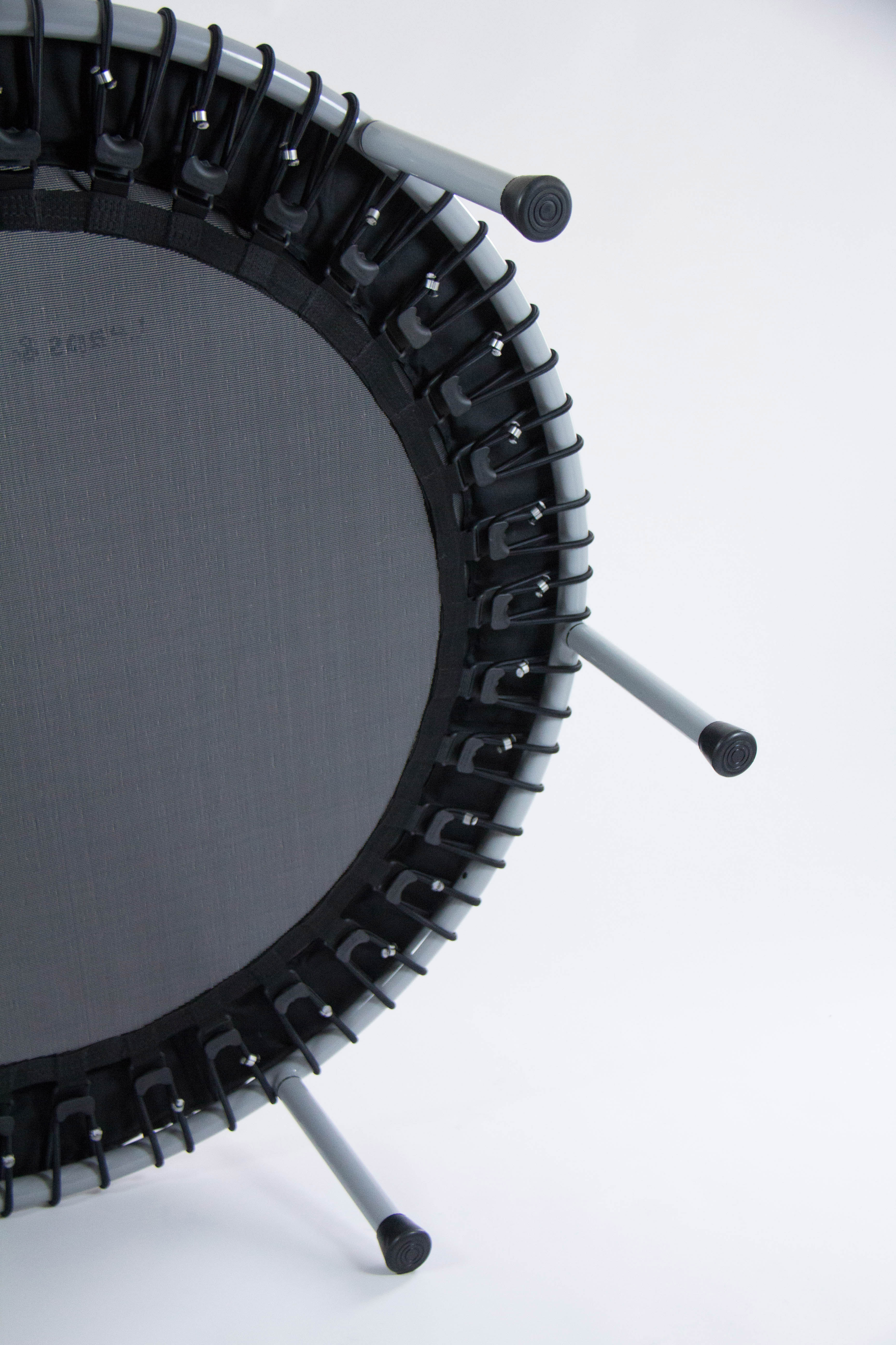 Close-up of a mini trampoline with black mat and legs