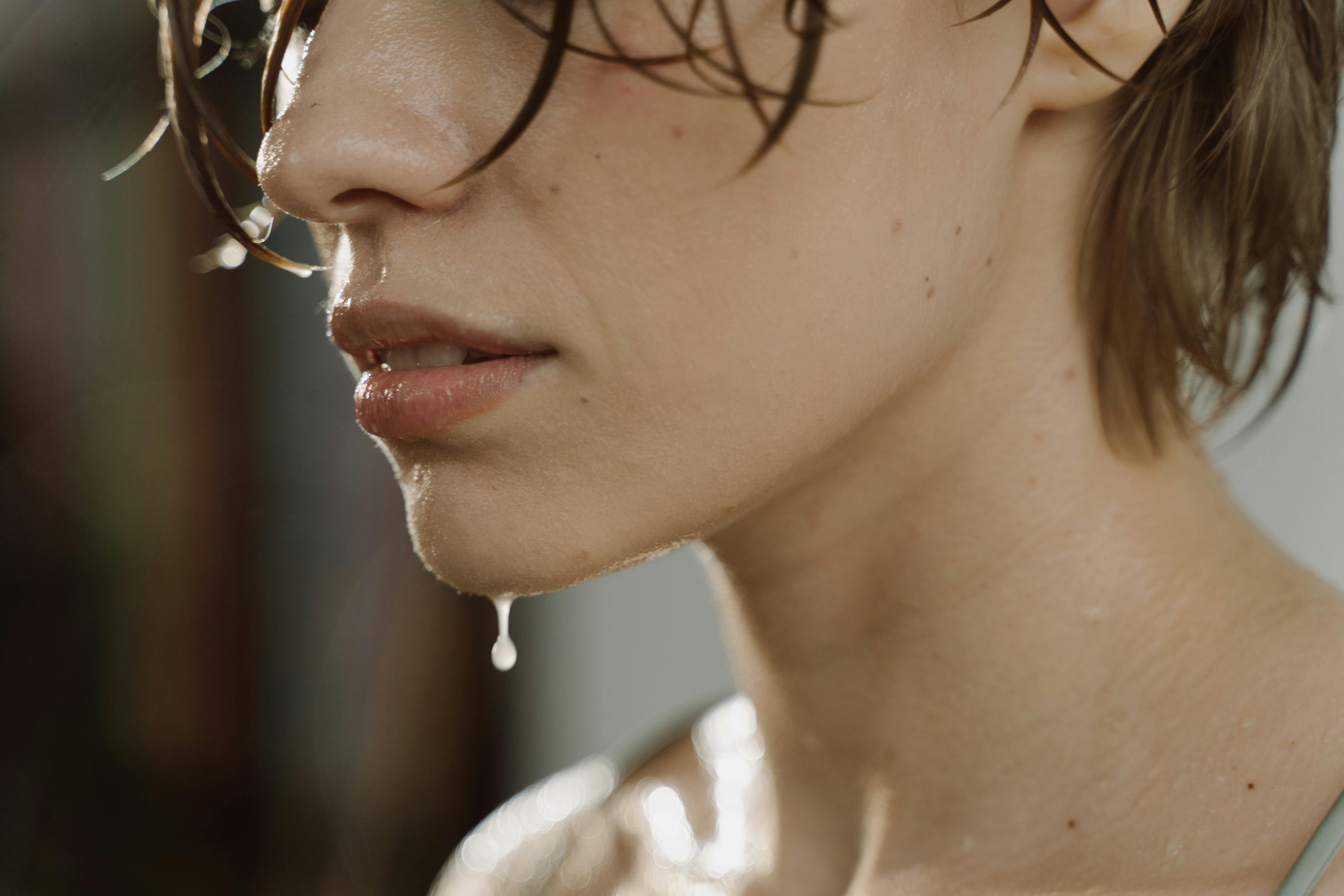 Close-up of person's wet face and chin, water dripping down.