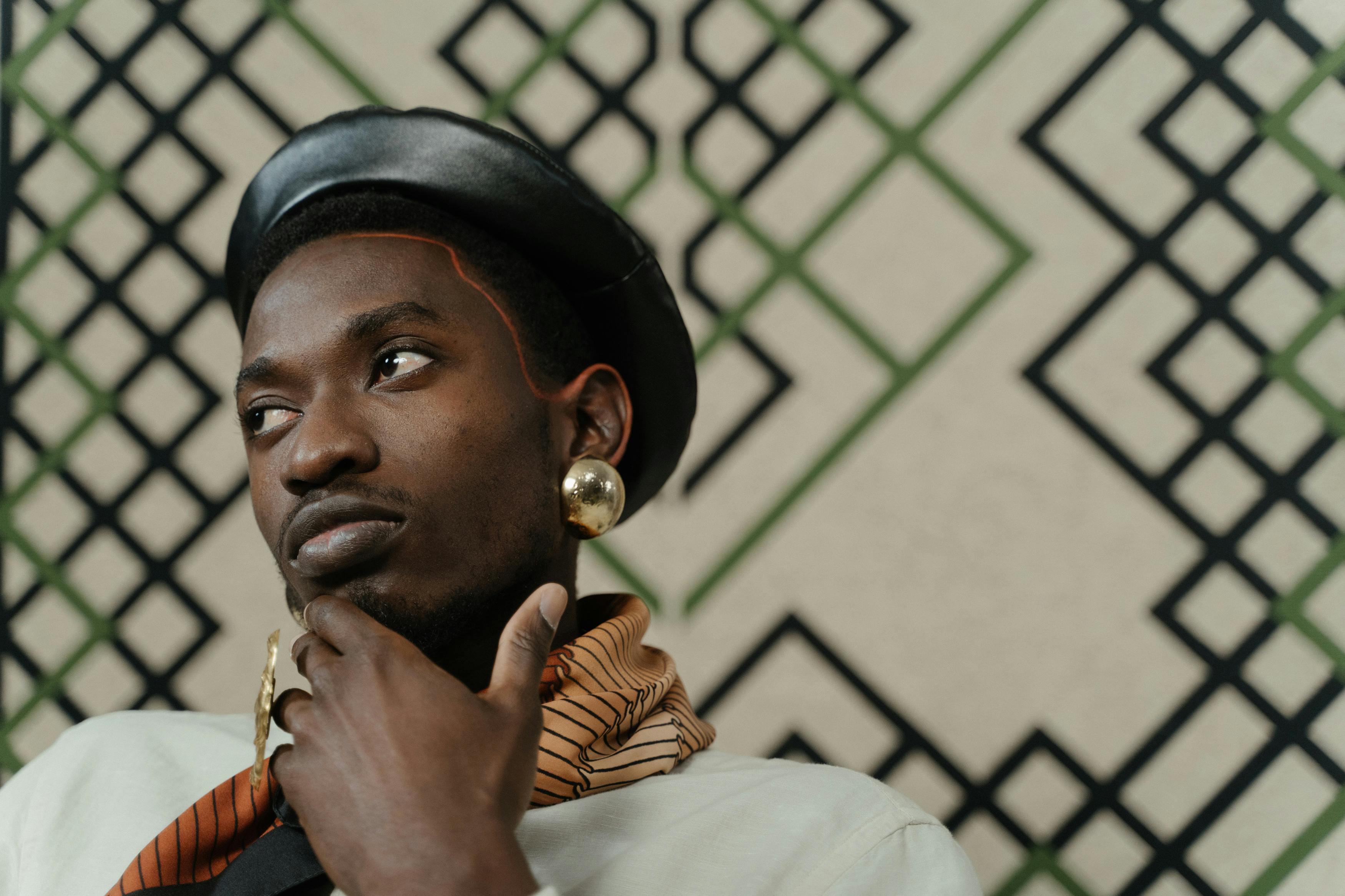 A person wearing a black beret and large gold earring.