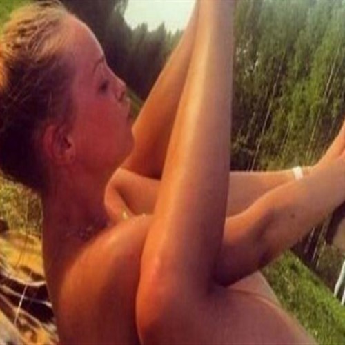 Woman in profile, lying on her back with legs raised.