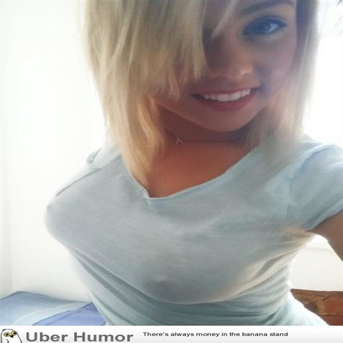 Blonde woman in a light blue t-shirt smiles at the camera.