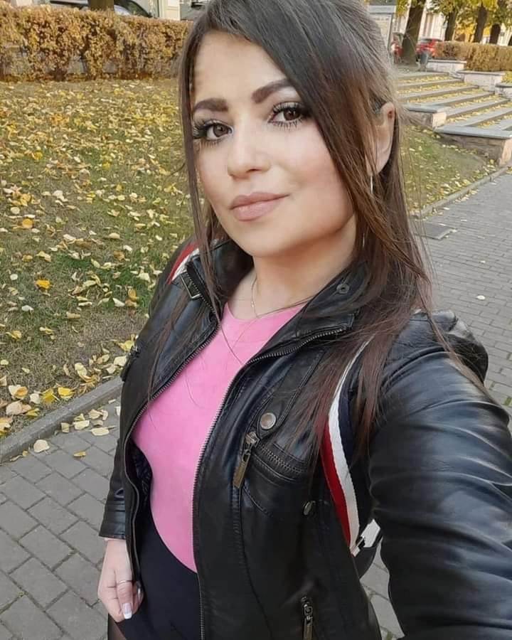 Indianapolis skyline at dusk with silhouettes of people.