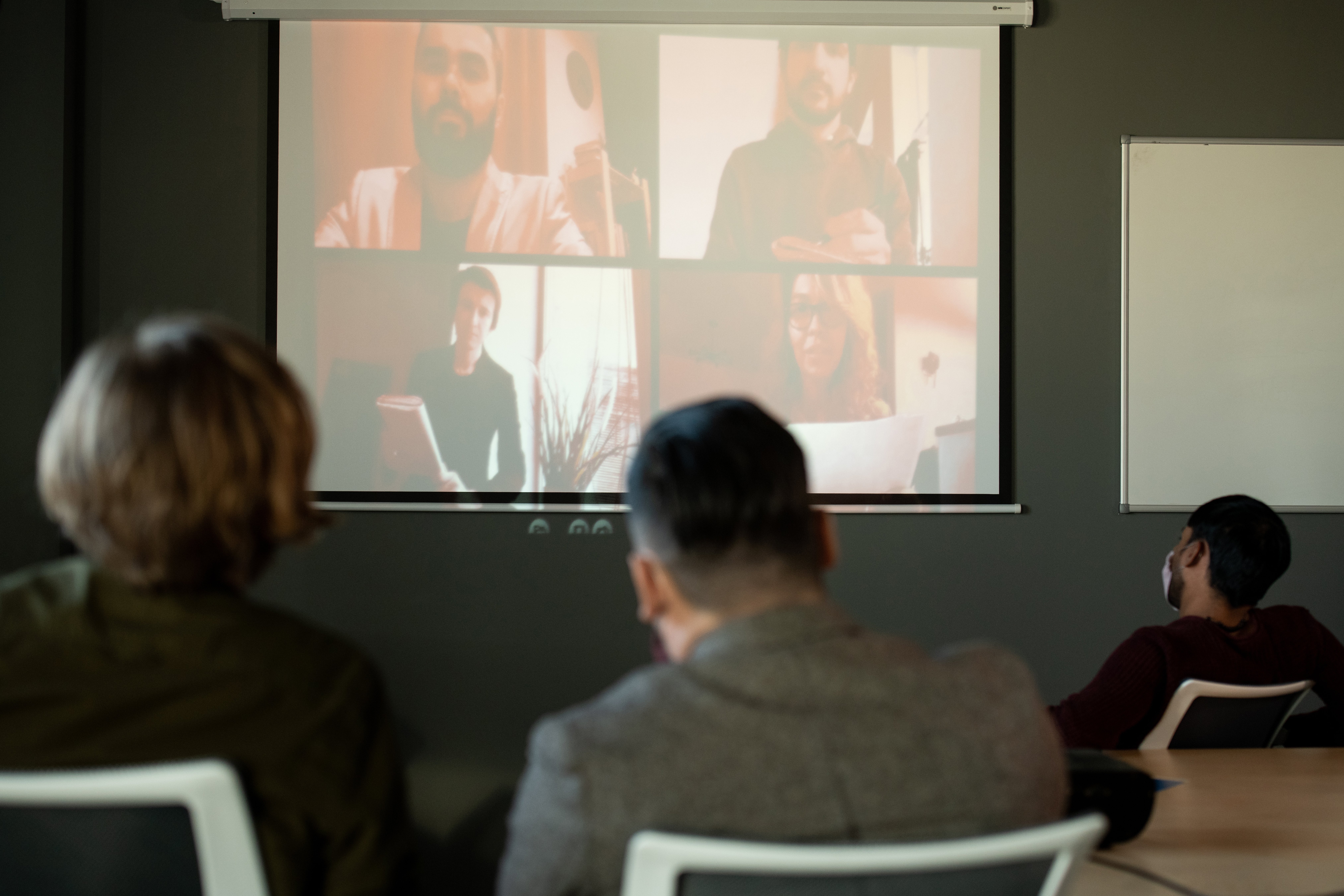 Diverse professionals participating in a video conference on laptops.